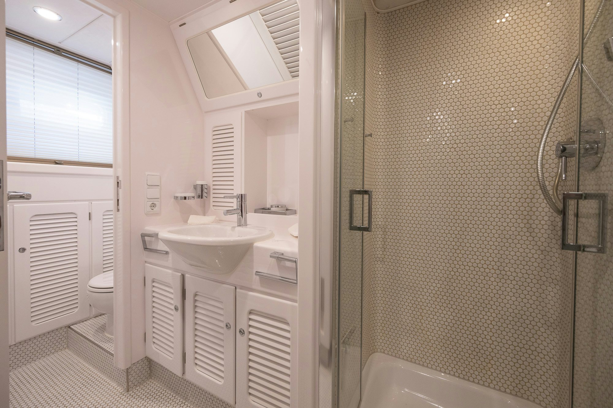 a bathroom with a sink and a shower unit aboard PLAYMOBIL Yacht for Sale