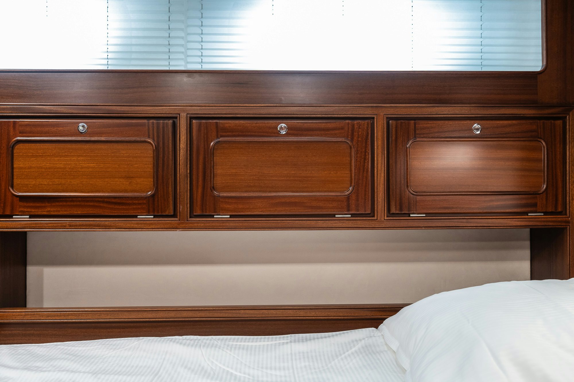 a wooden cabinet above a bed aboard PLAYMOBIL Yacht for Sale
