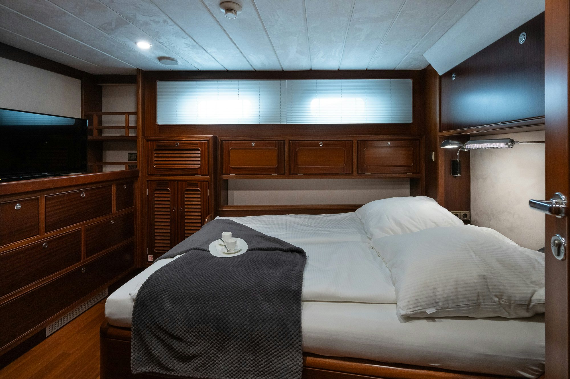 a bed with a black blanket aboard PLAYMOBIL Yacht for Sale