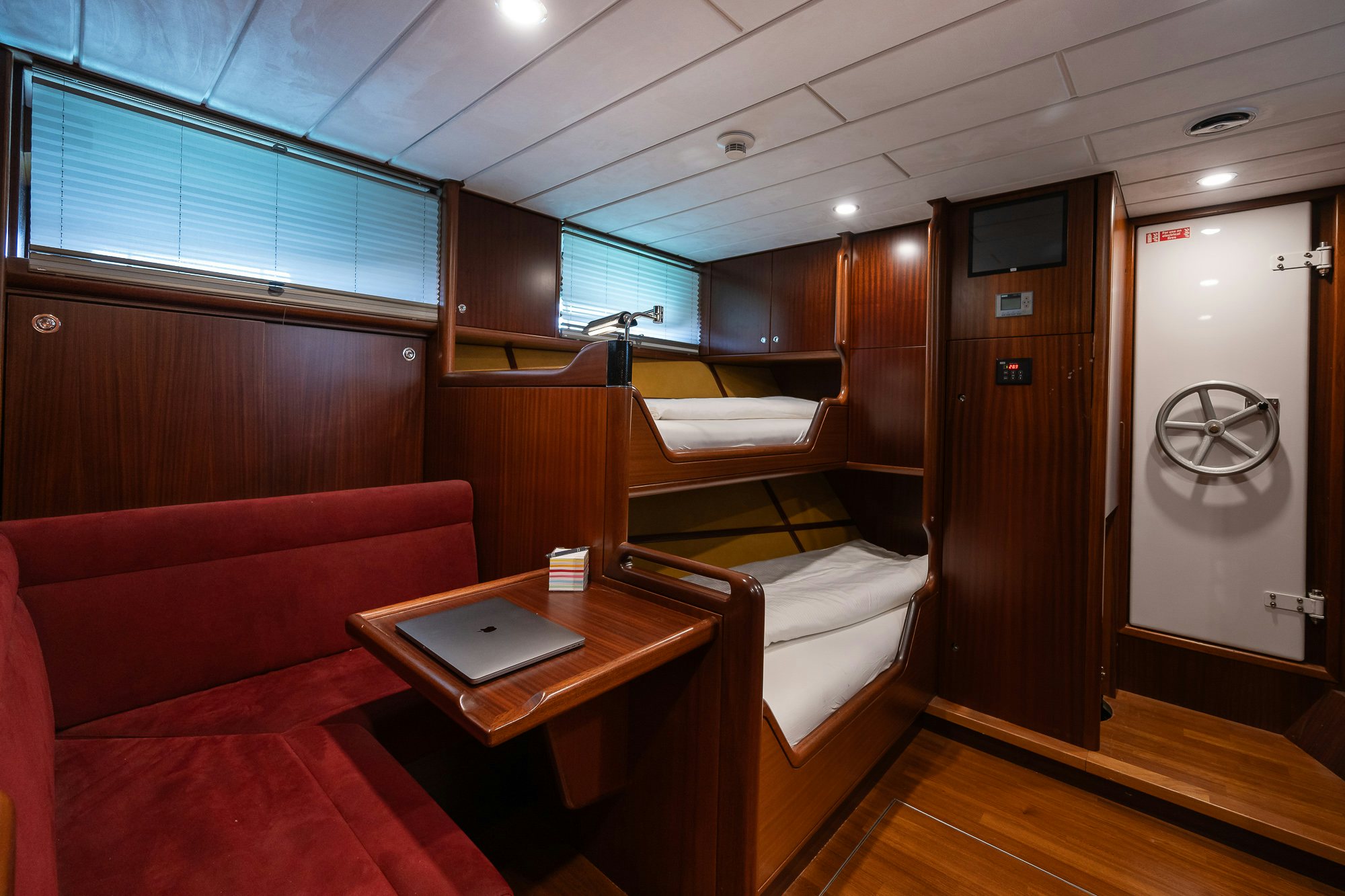 a room with a bed and desk aboard PLAYMOBIL Yacht for Sale