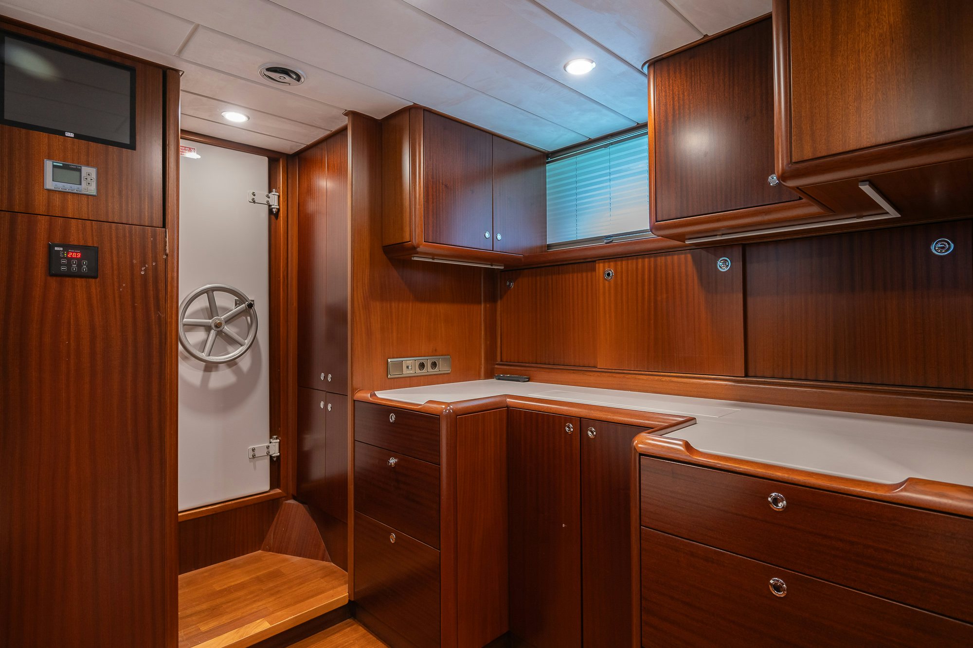 a room with wooden cabinets aboard PLAYMOBIL Yacht for Sale