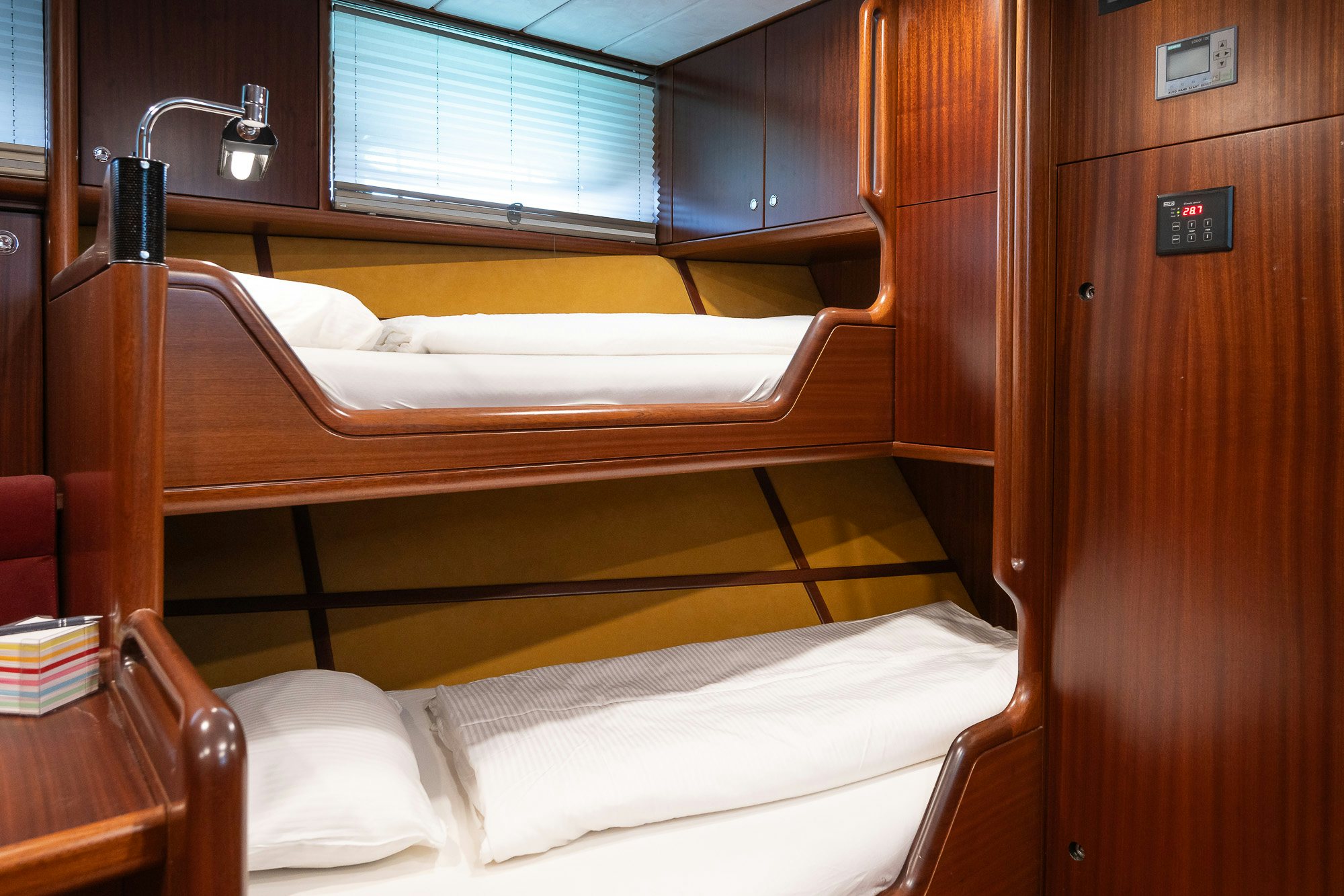 a bed with a wooden headboard aboard PLAYMOBIL Yacht for Sale