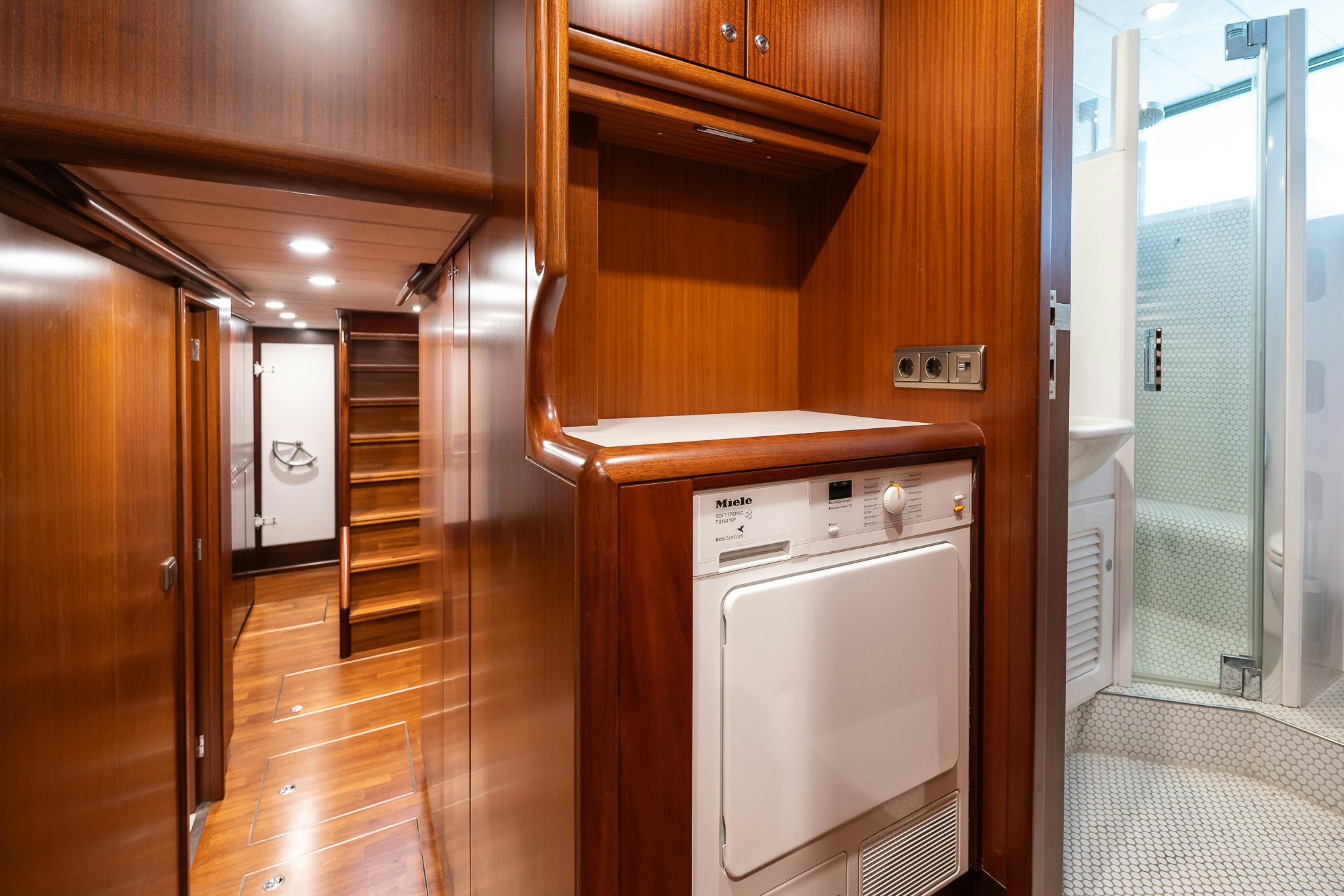 a kitchen with wooden cabinets aboard PLAYMOBIL Yacht for Sale
