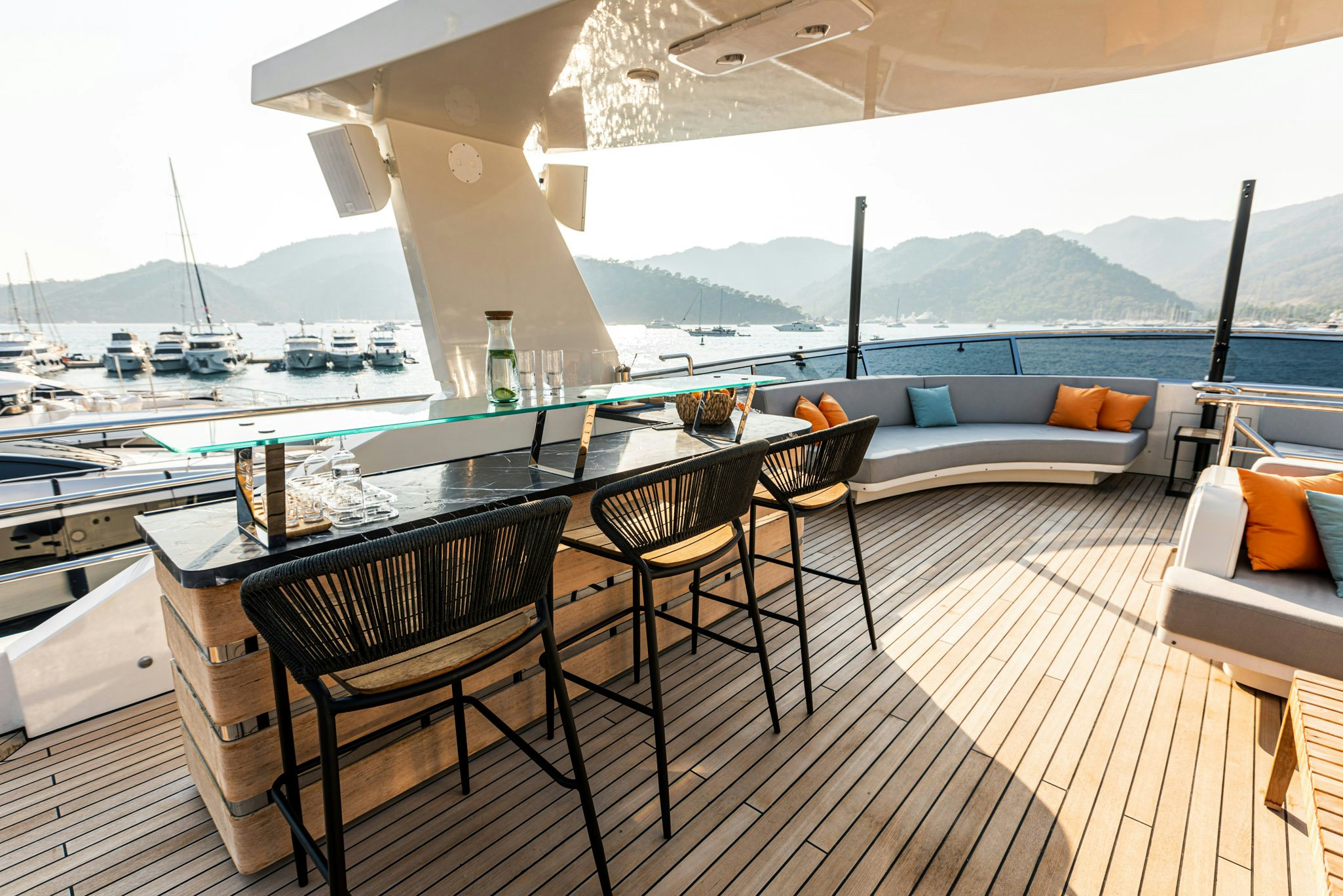 a table and chairs on a balcony aboard ZEEMAR Yacht for Charter