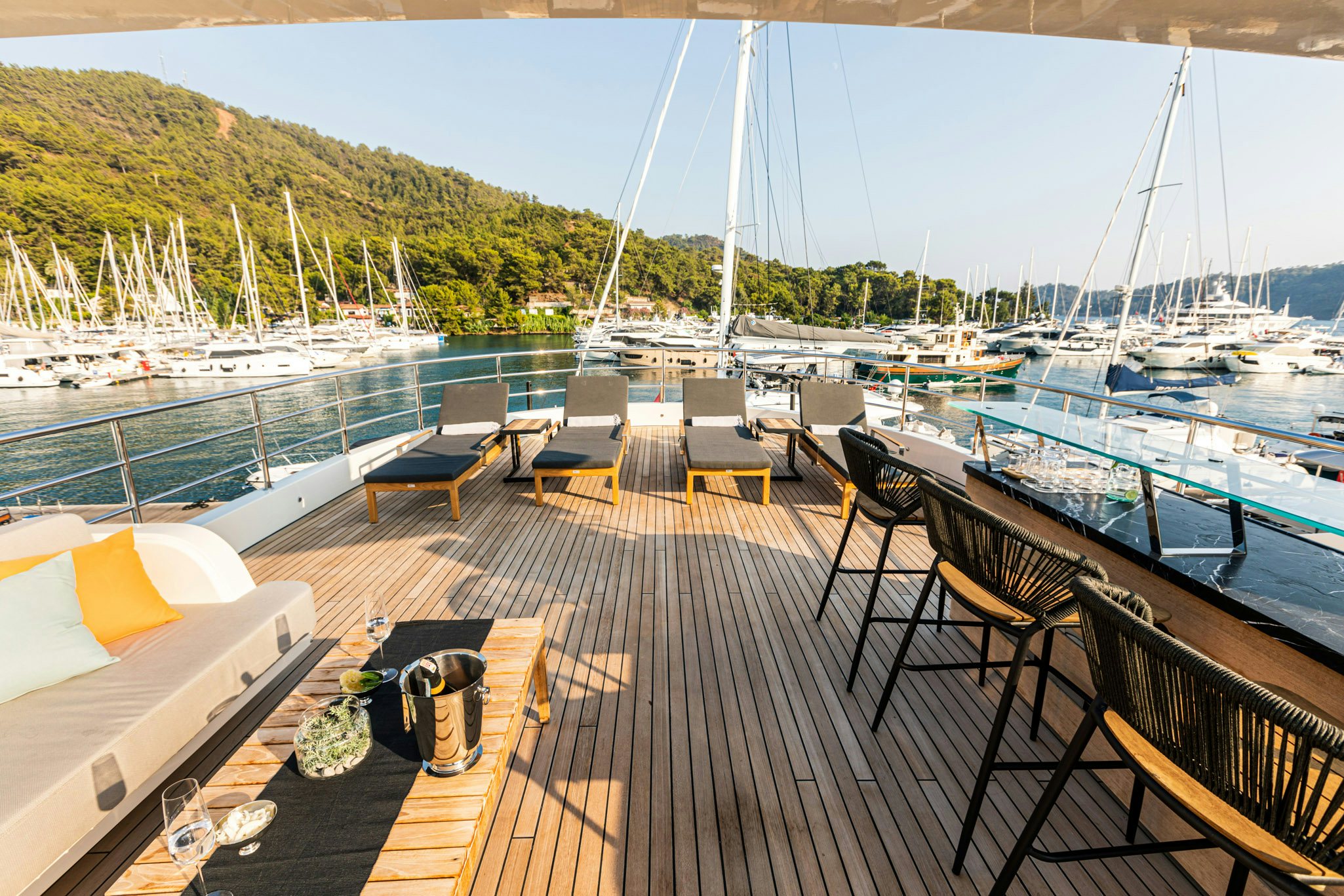 a deck with a view of a marina and boats aboard ZEEMAR Yacht for Charter