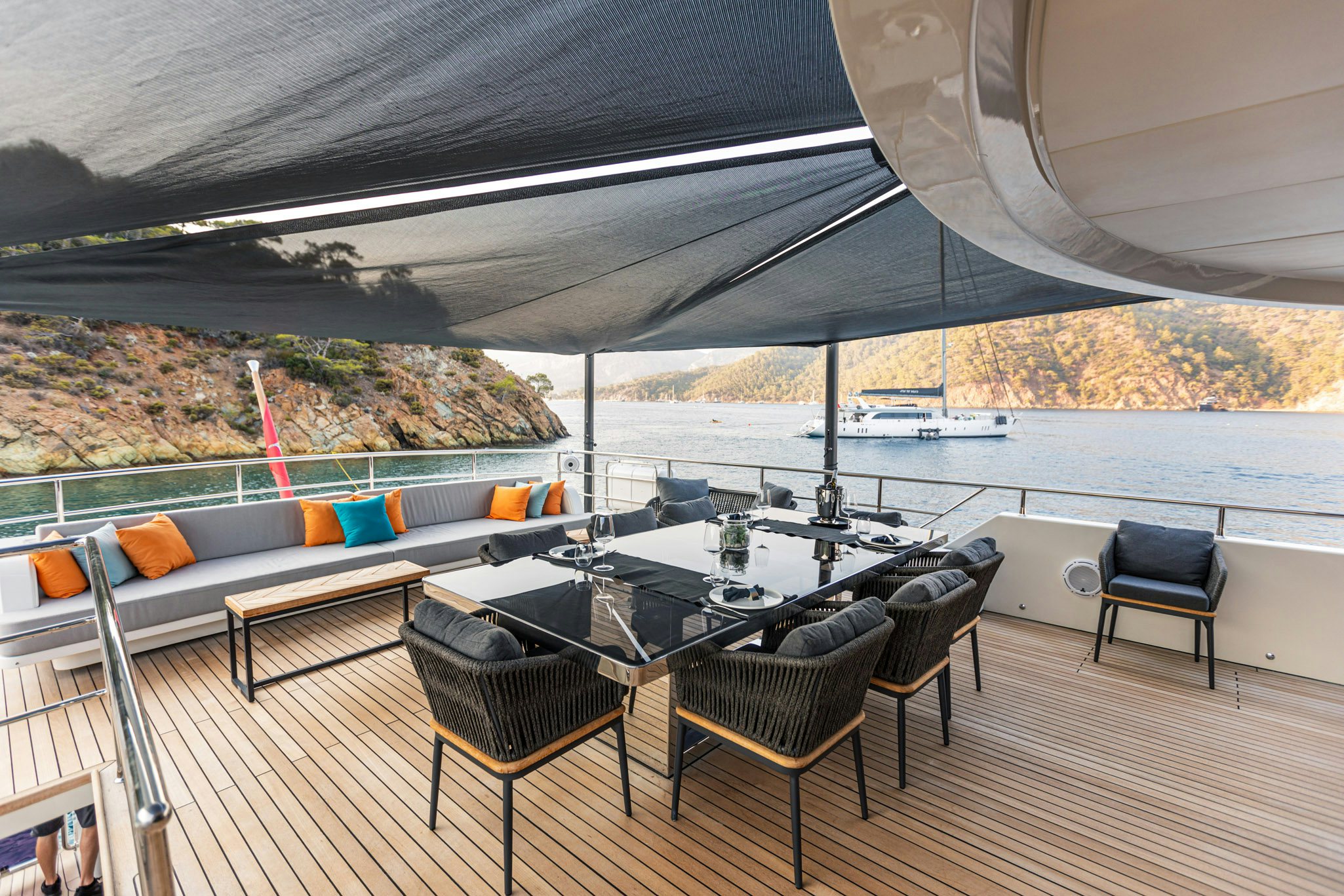 a deck with a table and chairs aboard ZEEMAR Yacht for Charter