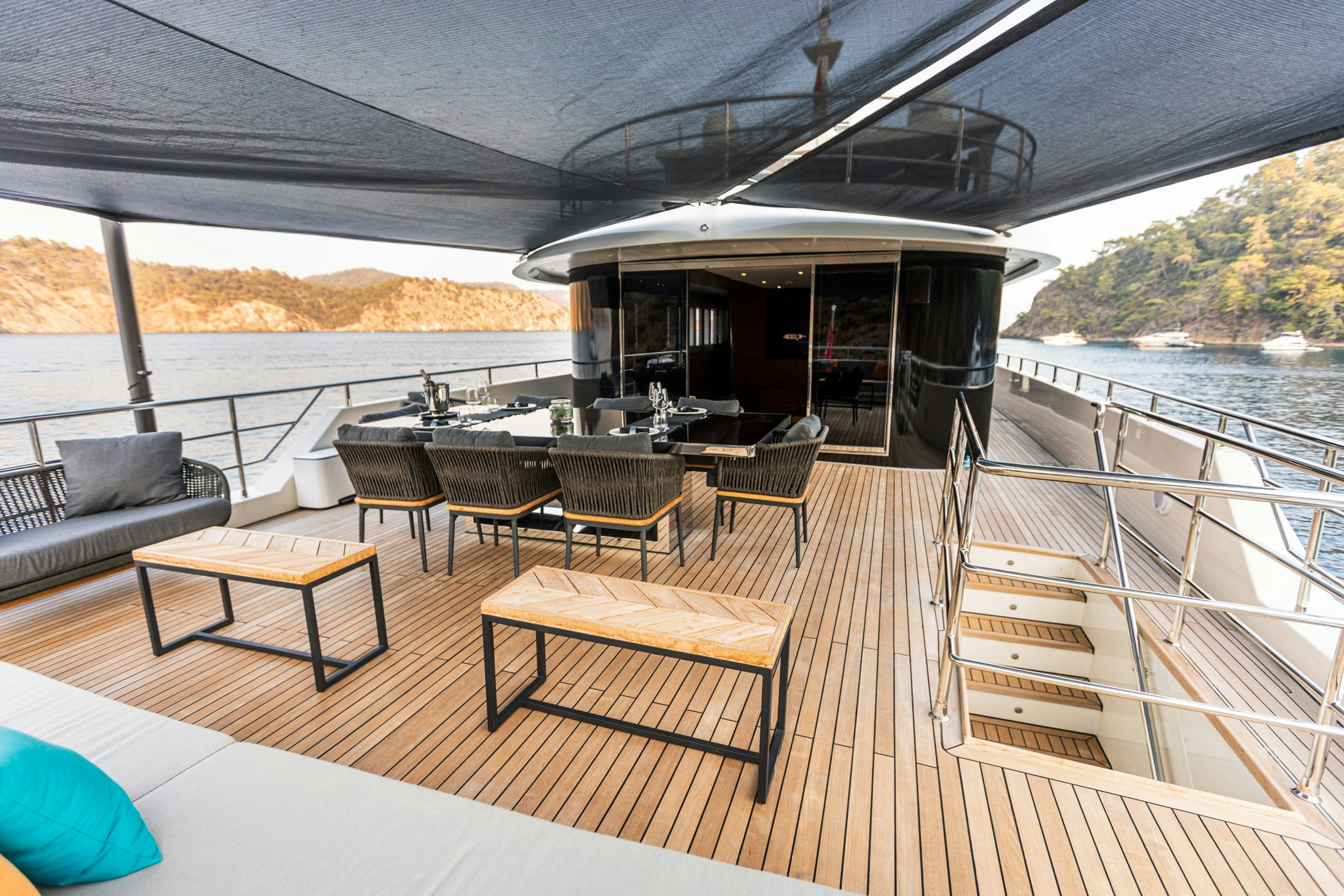 a deck with tables and chairs aboard ZEEMAR Yacht for Charter