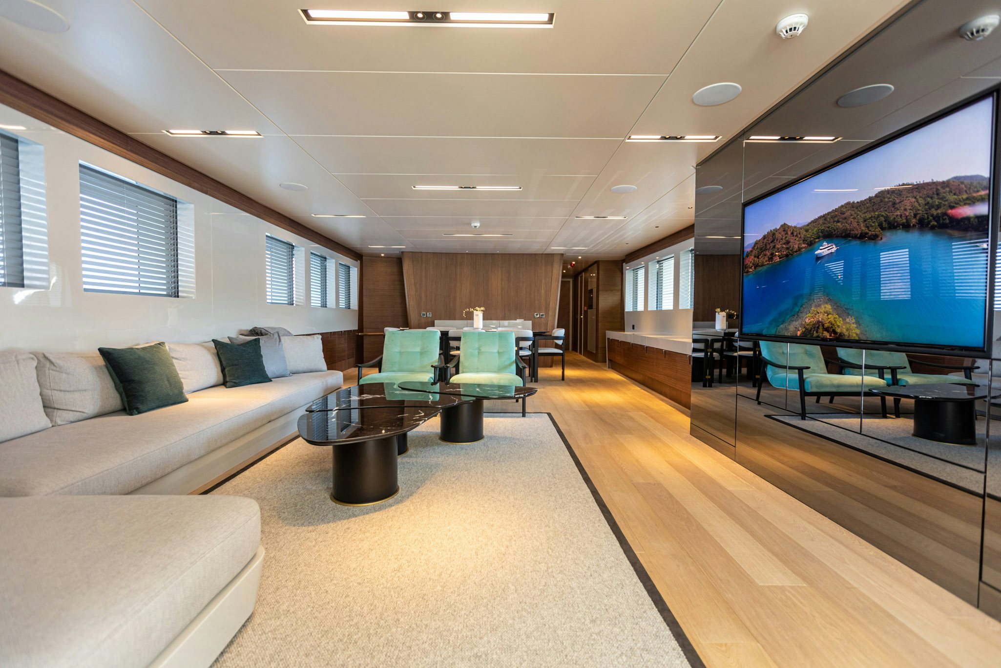 a living room with a large screen aboard ZEEMAR Yacht for Charter