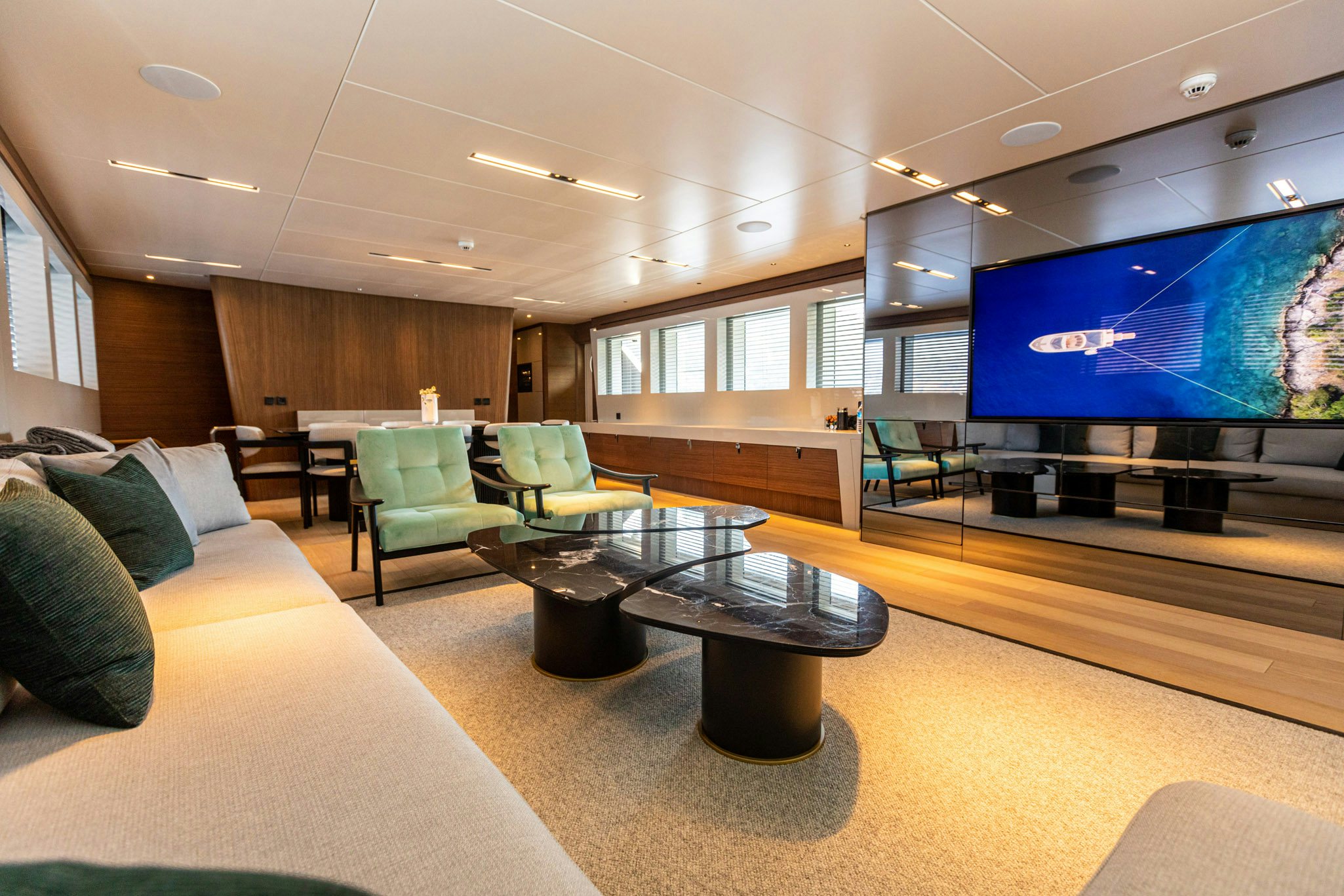 a living room with a large screen aboard ZEEMAR Yacht for Charter