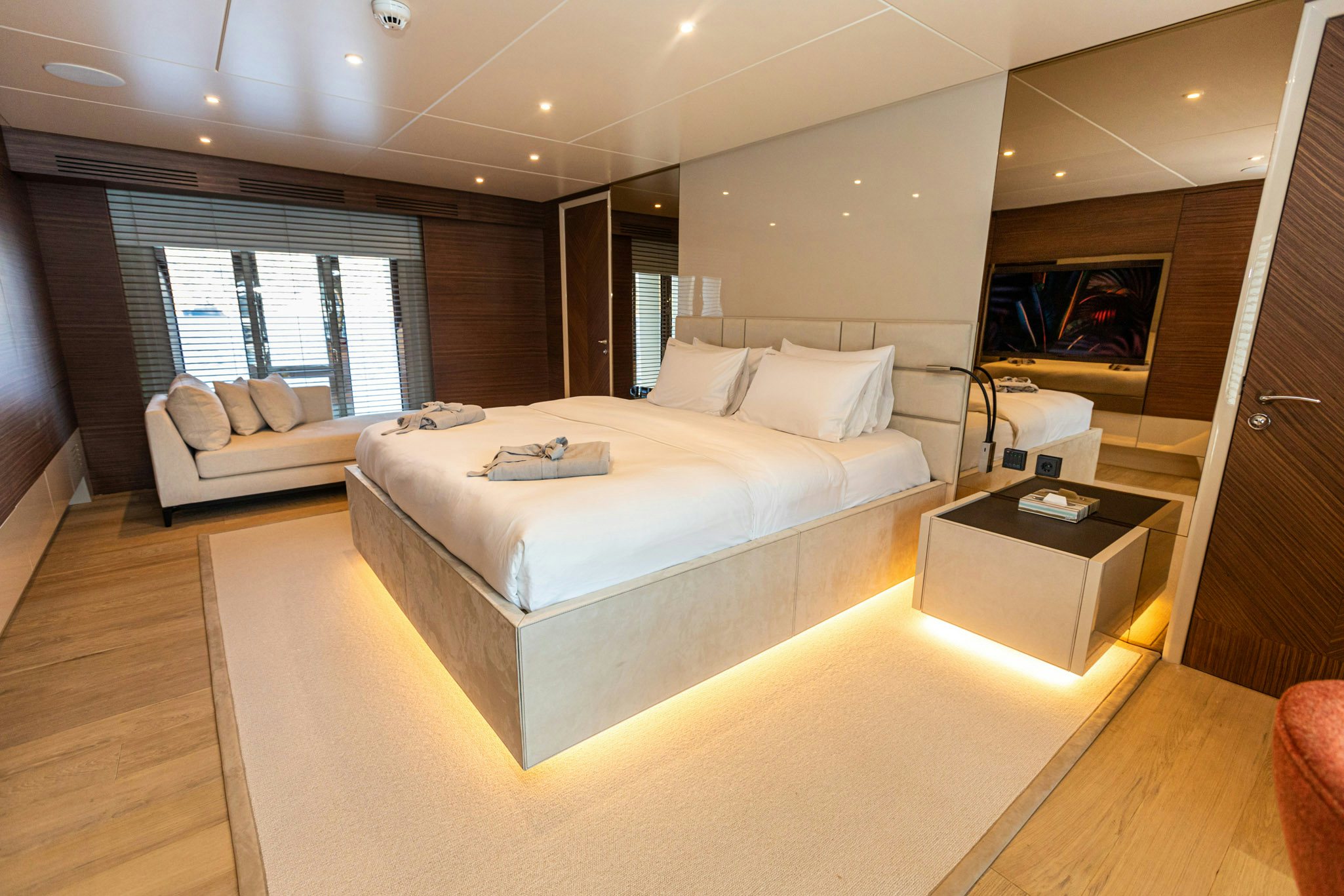 a room with a bed and a table aboard ZEEMAR Yacht for Charter