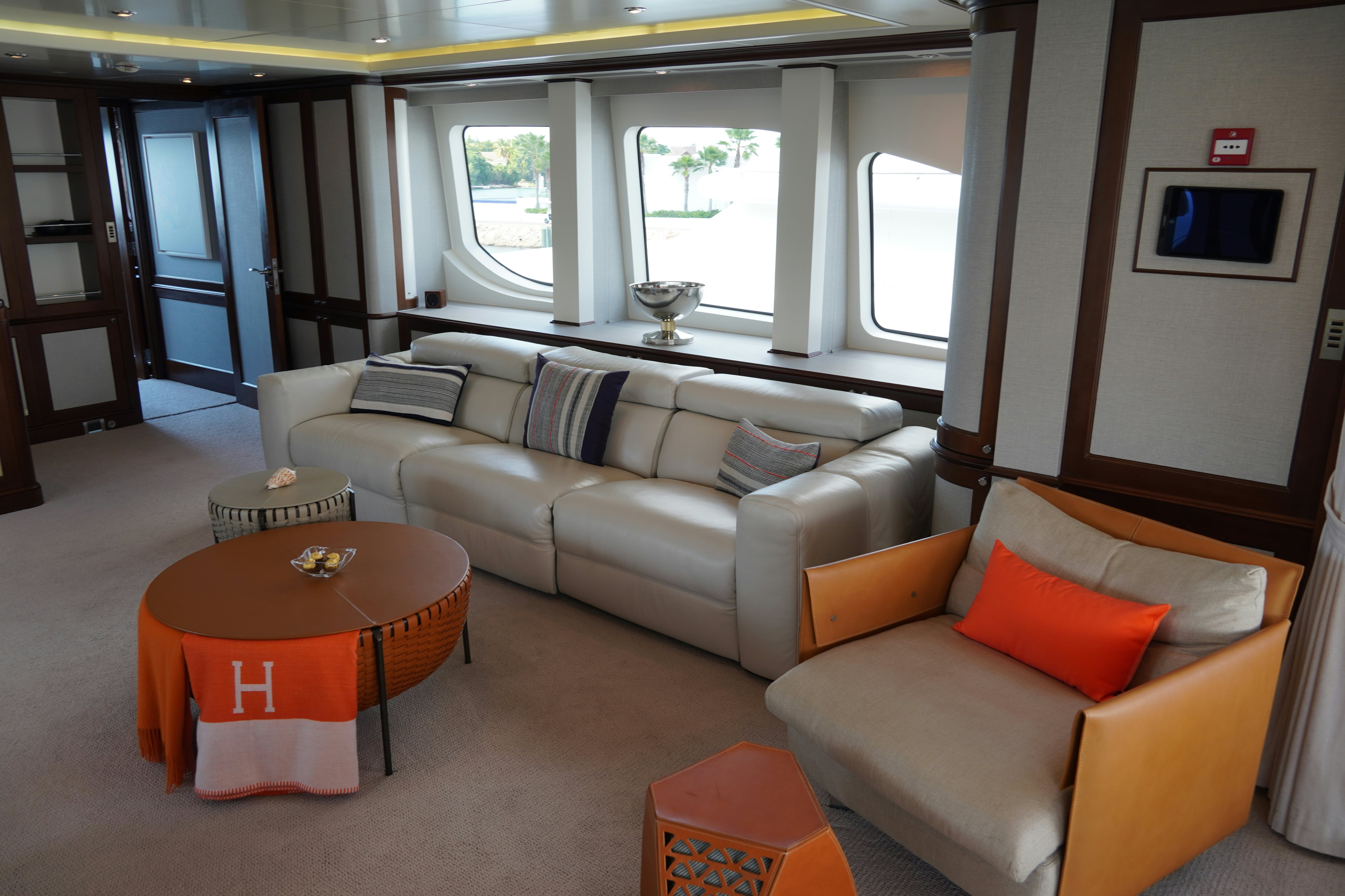 a living room with a couch and a table aboard PAPAITO Yacht for Charter