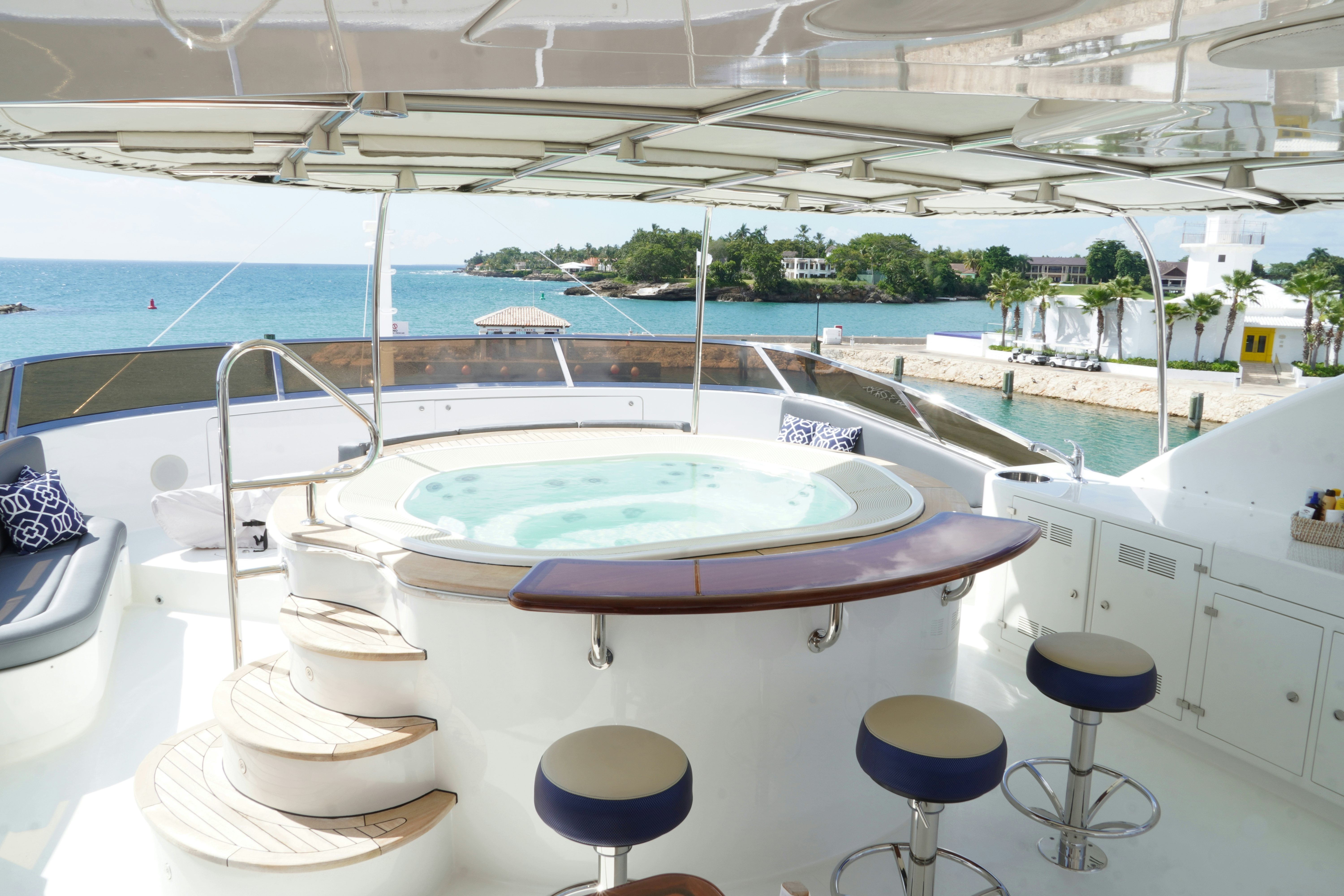 a pool with a table and chairs aboard PAPAITO Yacht for Charter