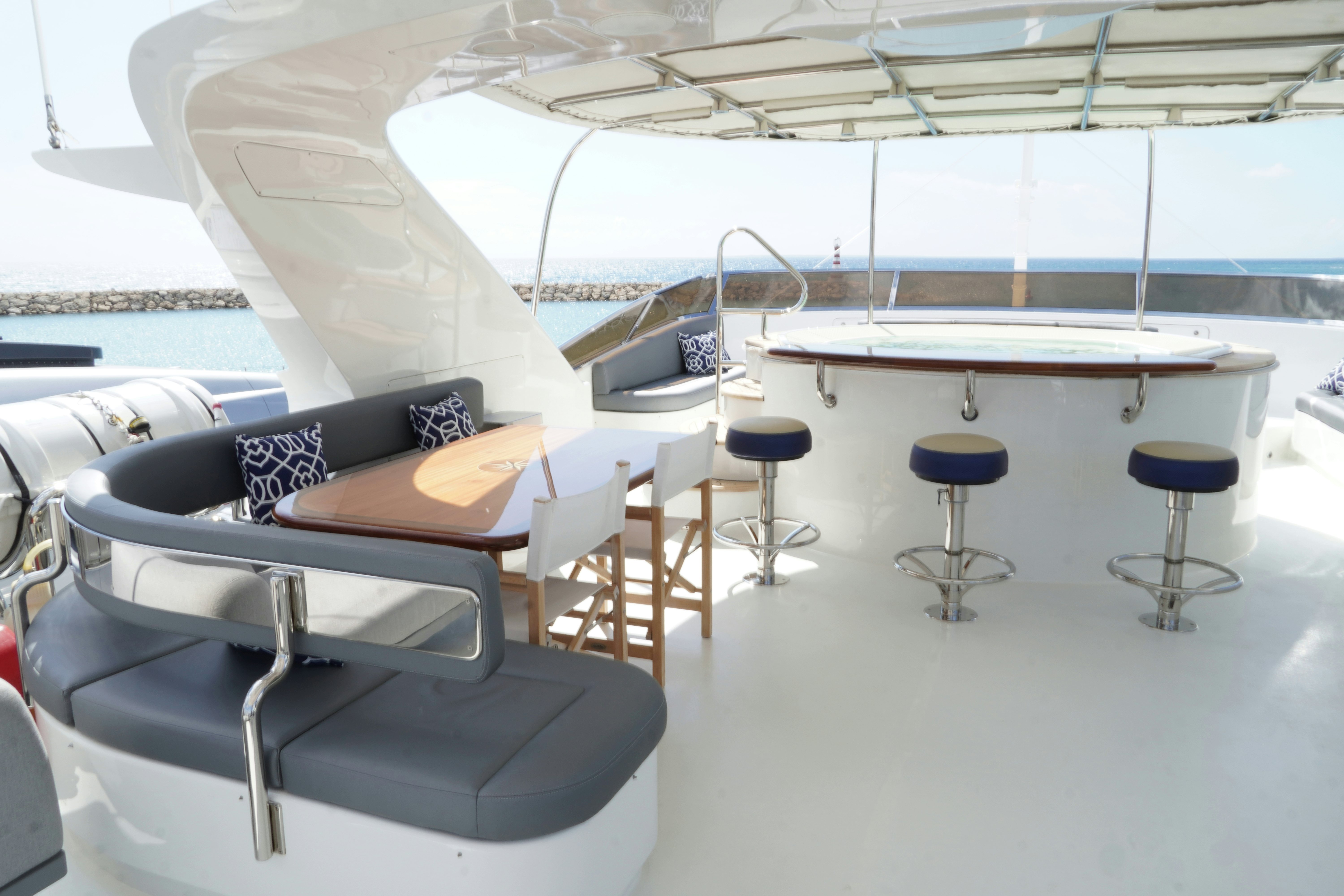a room with tables and chairs aboard PAPAITO Yacht for Charter