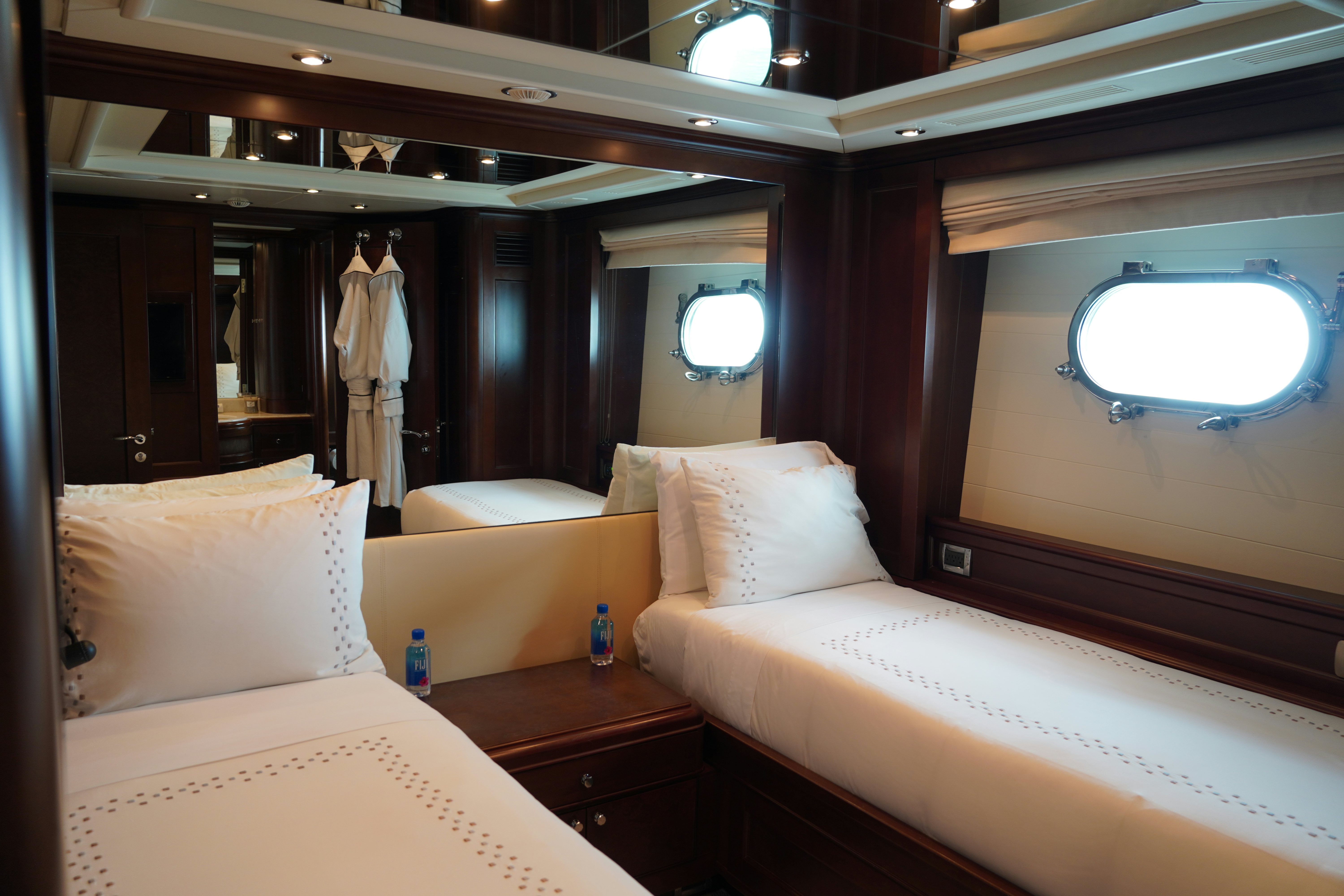 a room with beds and a window aboard PAPAITO Yacht for Charter