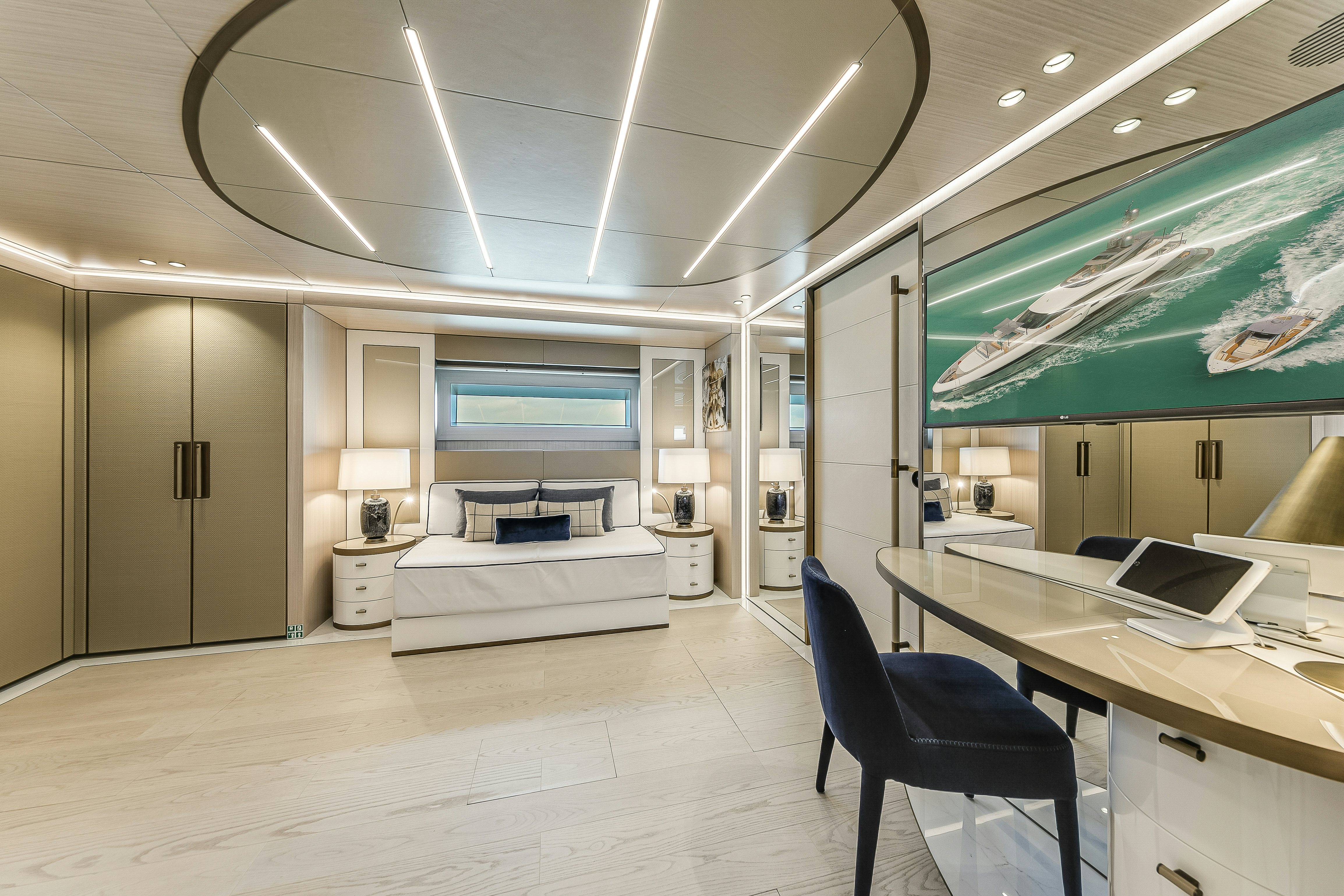 a room with a bed and a desk aboard EIV Yacht for Sale