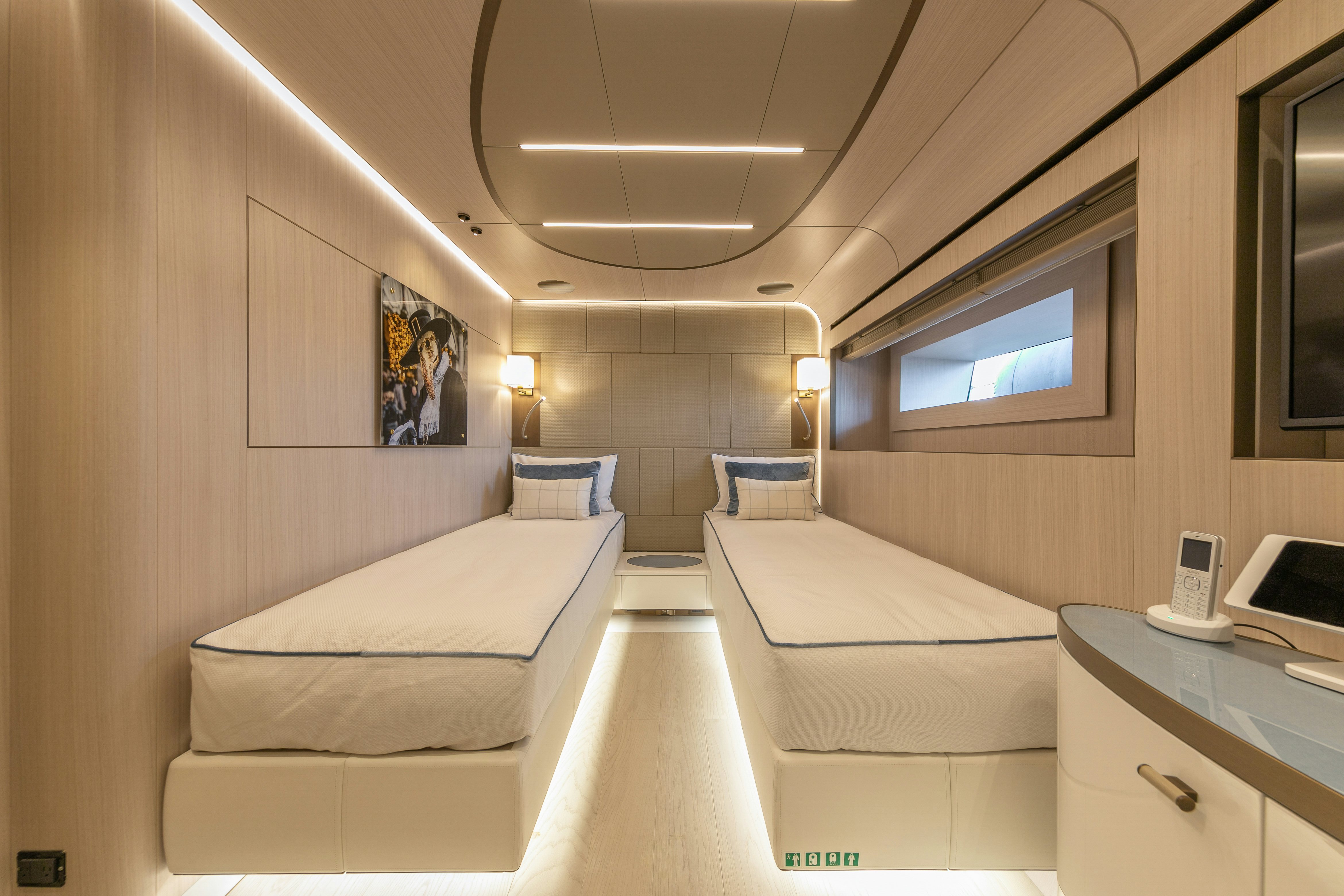a room with beds and a tv aboard EIV Yacht for Sale