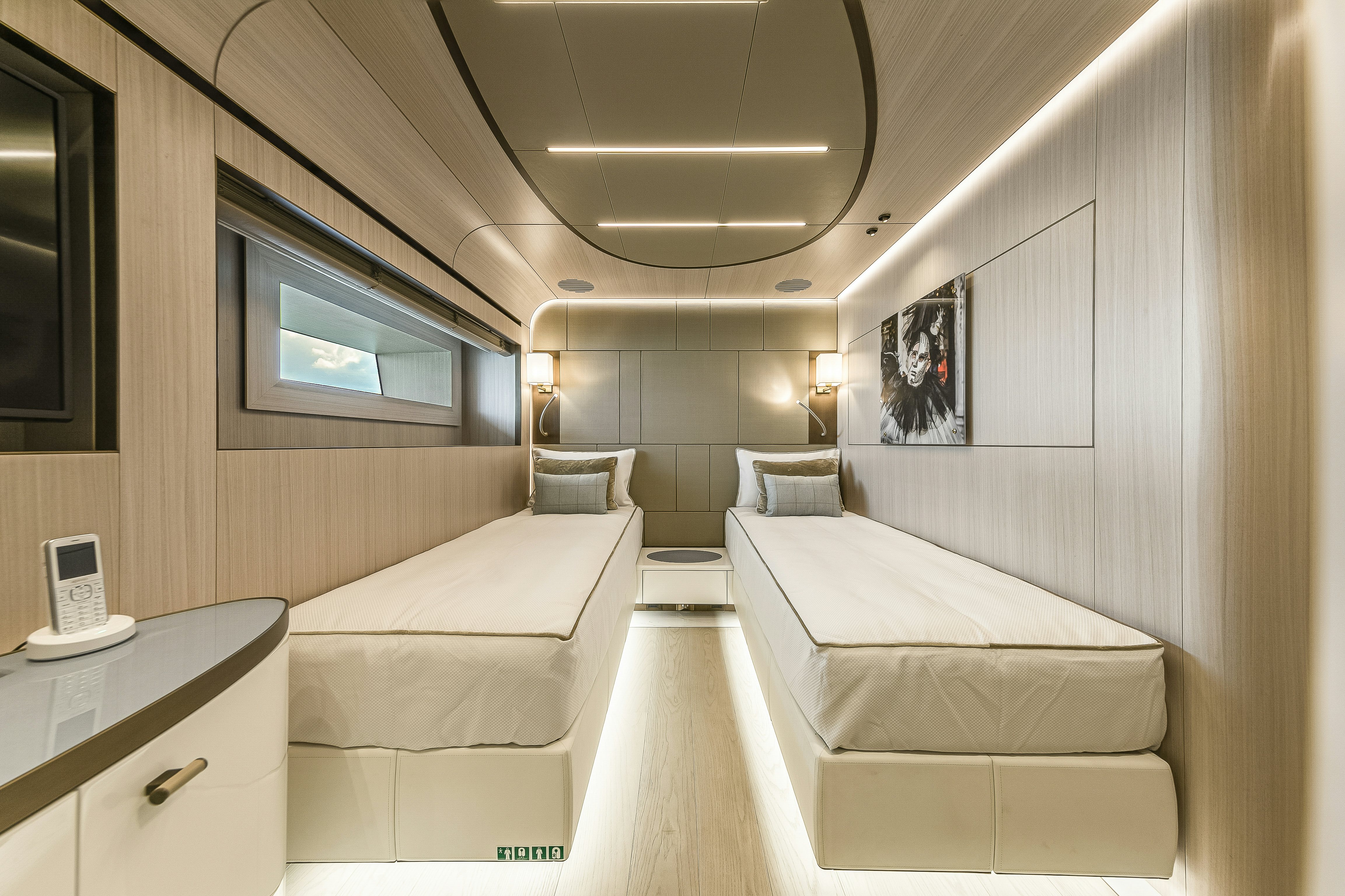 a room with beds and a phone aboard EIV Yacht for Sale