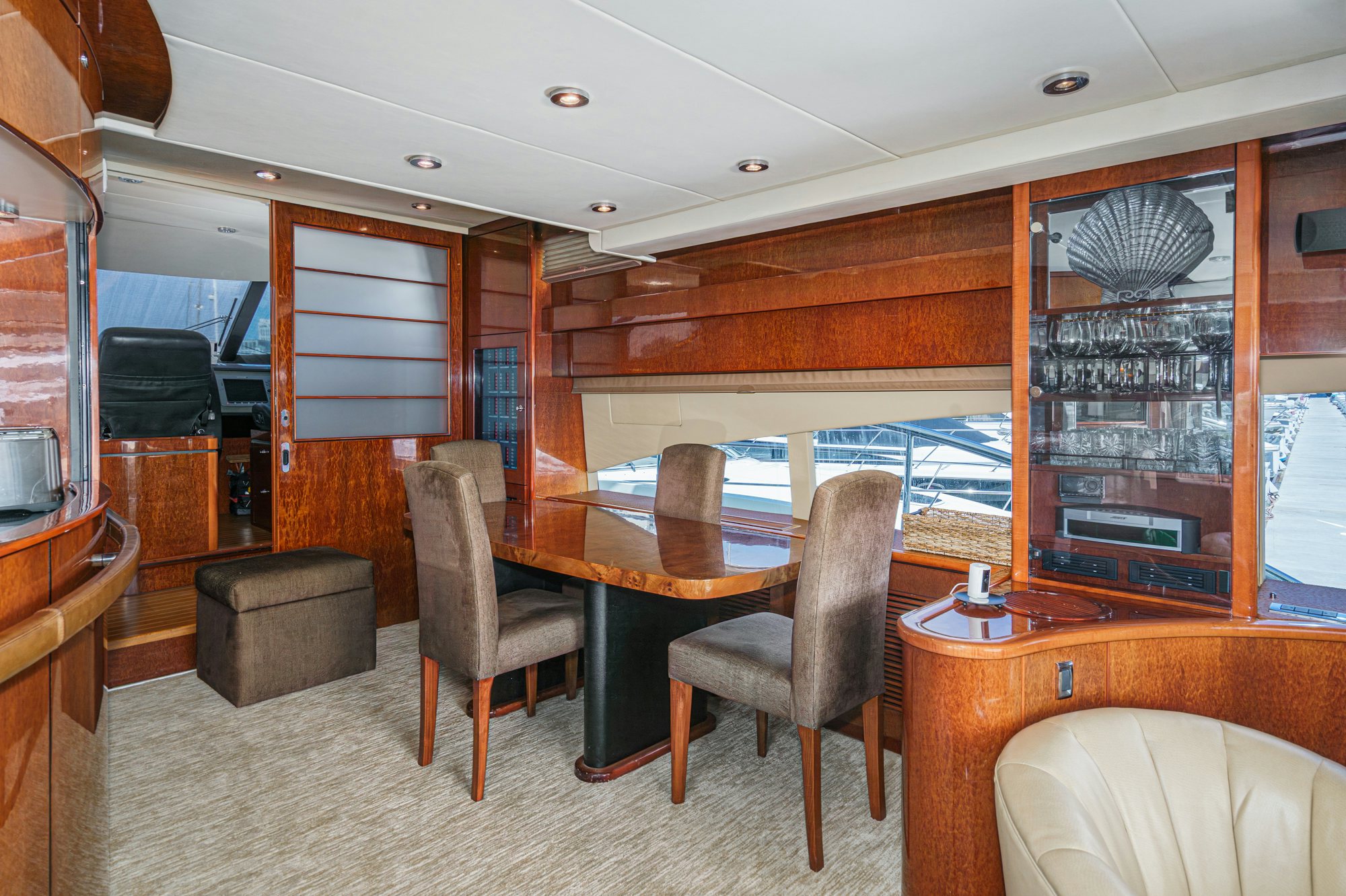 a room with a table chairs and a large window aboard COMPASS ROSE Yacht for Sale