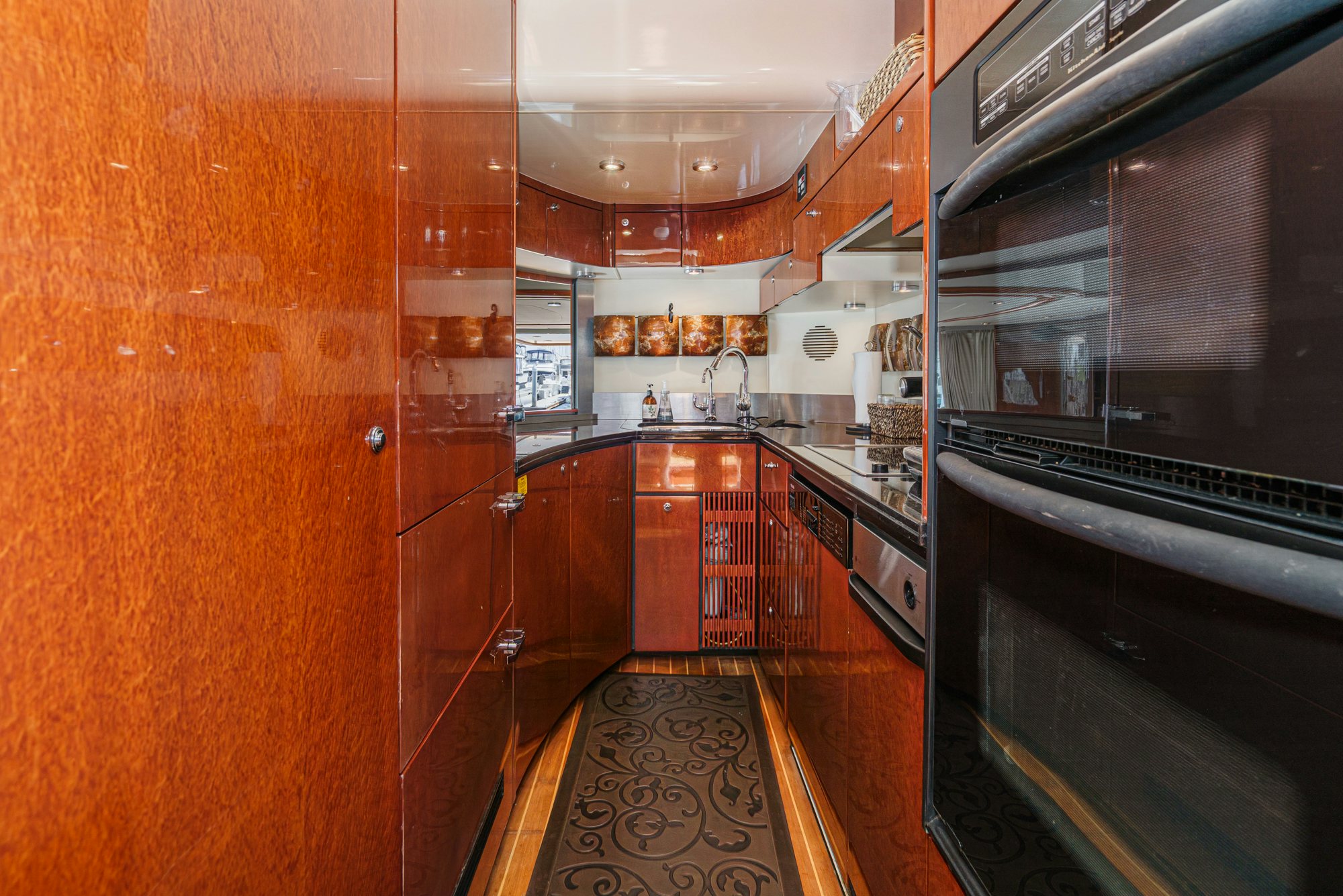 a kitchen with wooden cabinets aboard COMPASS ROSE Yacht for Sale