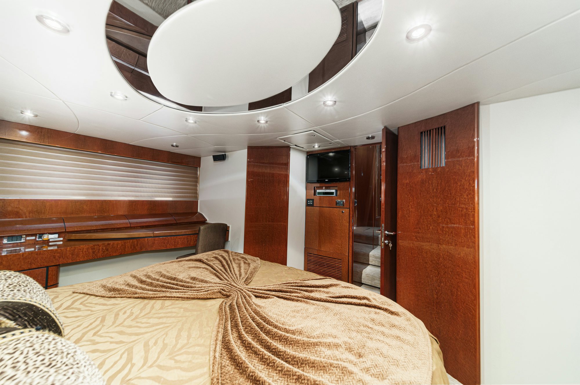 a bedroom with a bed and a ceiling fan aboard COMPASS ROSE Yacht for Sale