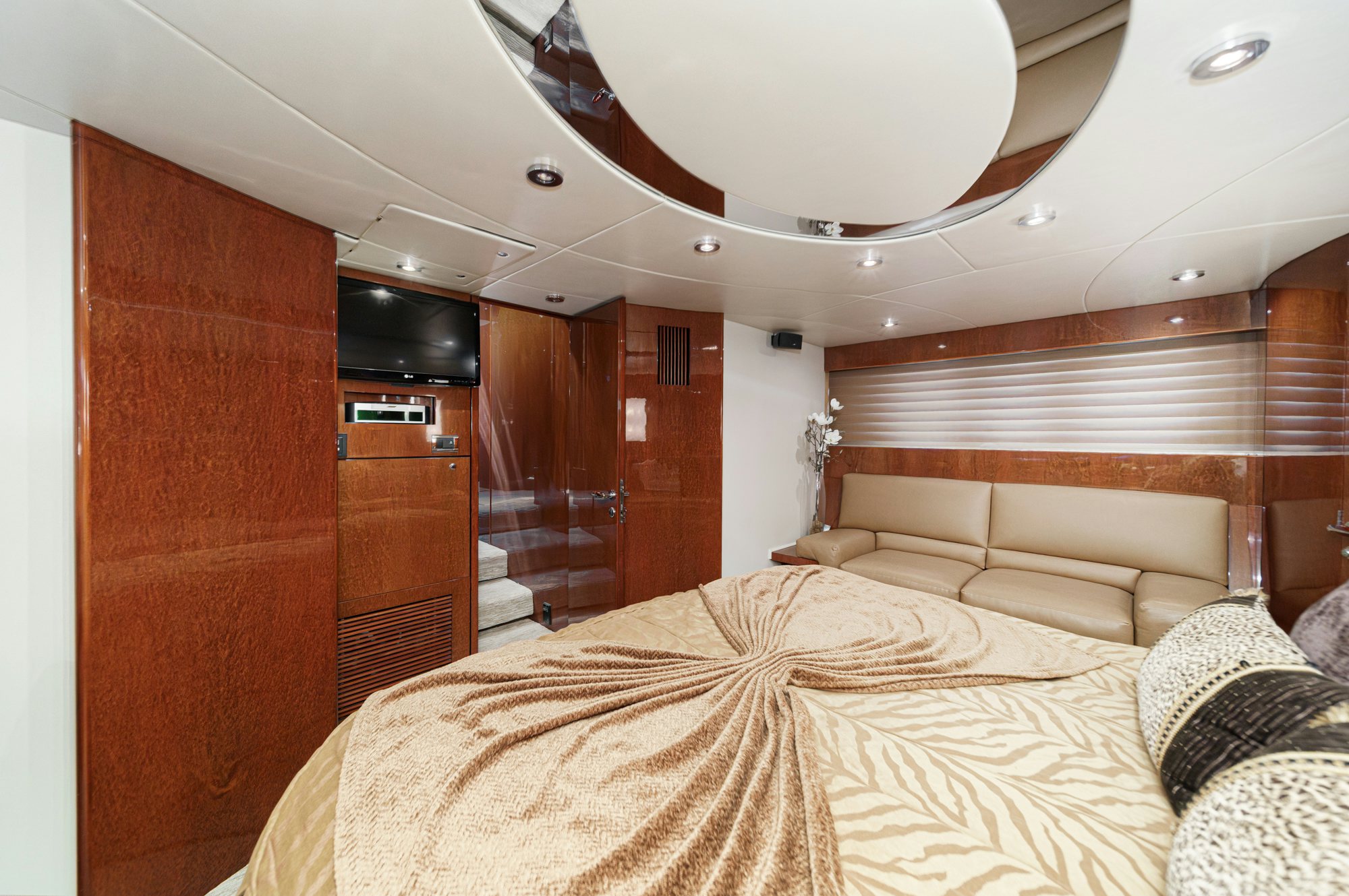 a bedroom with a bed and a ceiling fan aboard COMPASS ROSE Yacht for Sale