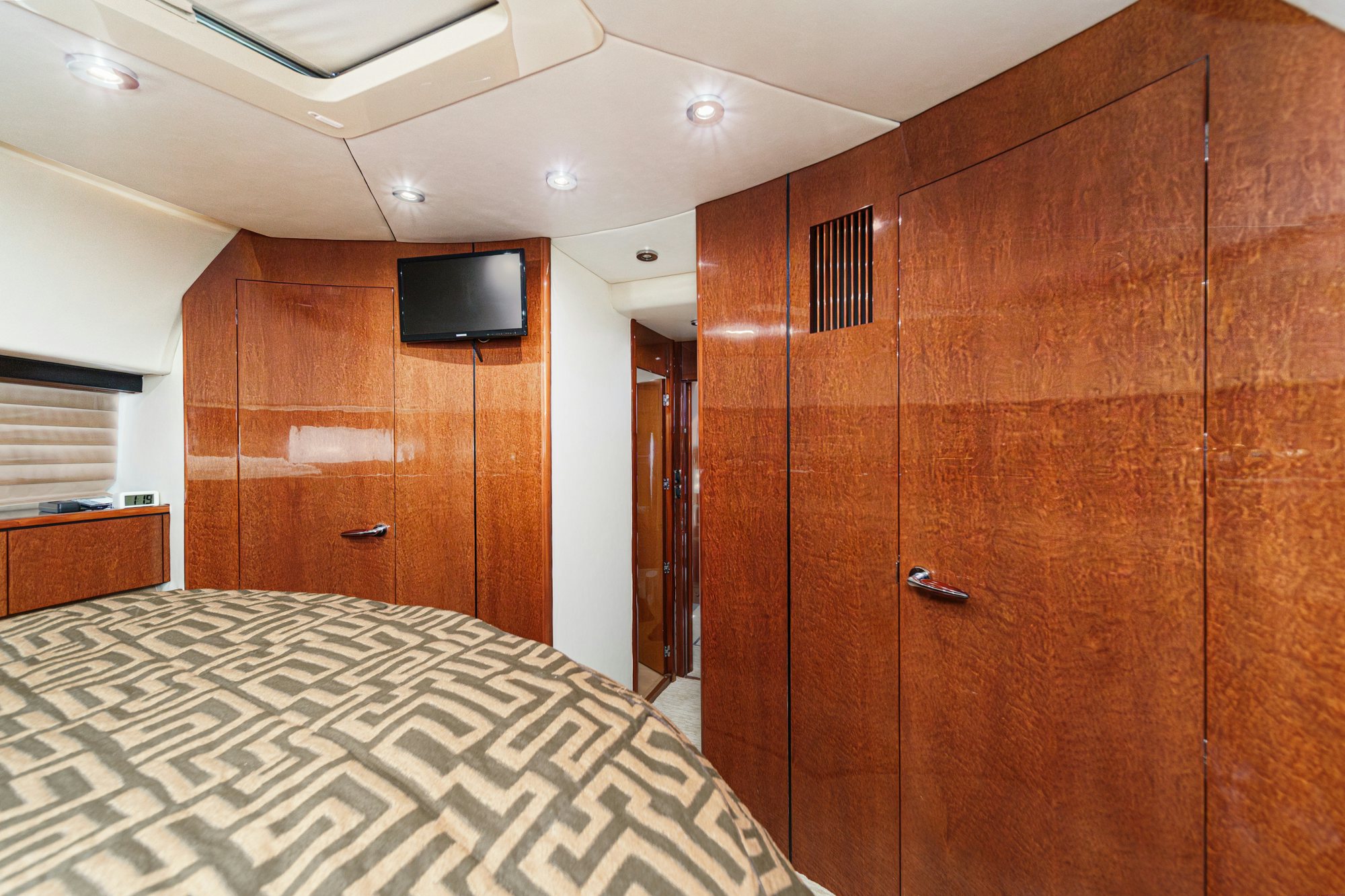 a room with a bed and a television aboard COMPASS ROSE Yacht for Sale