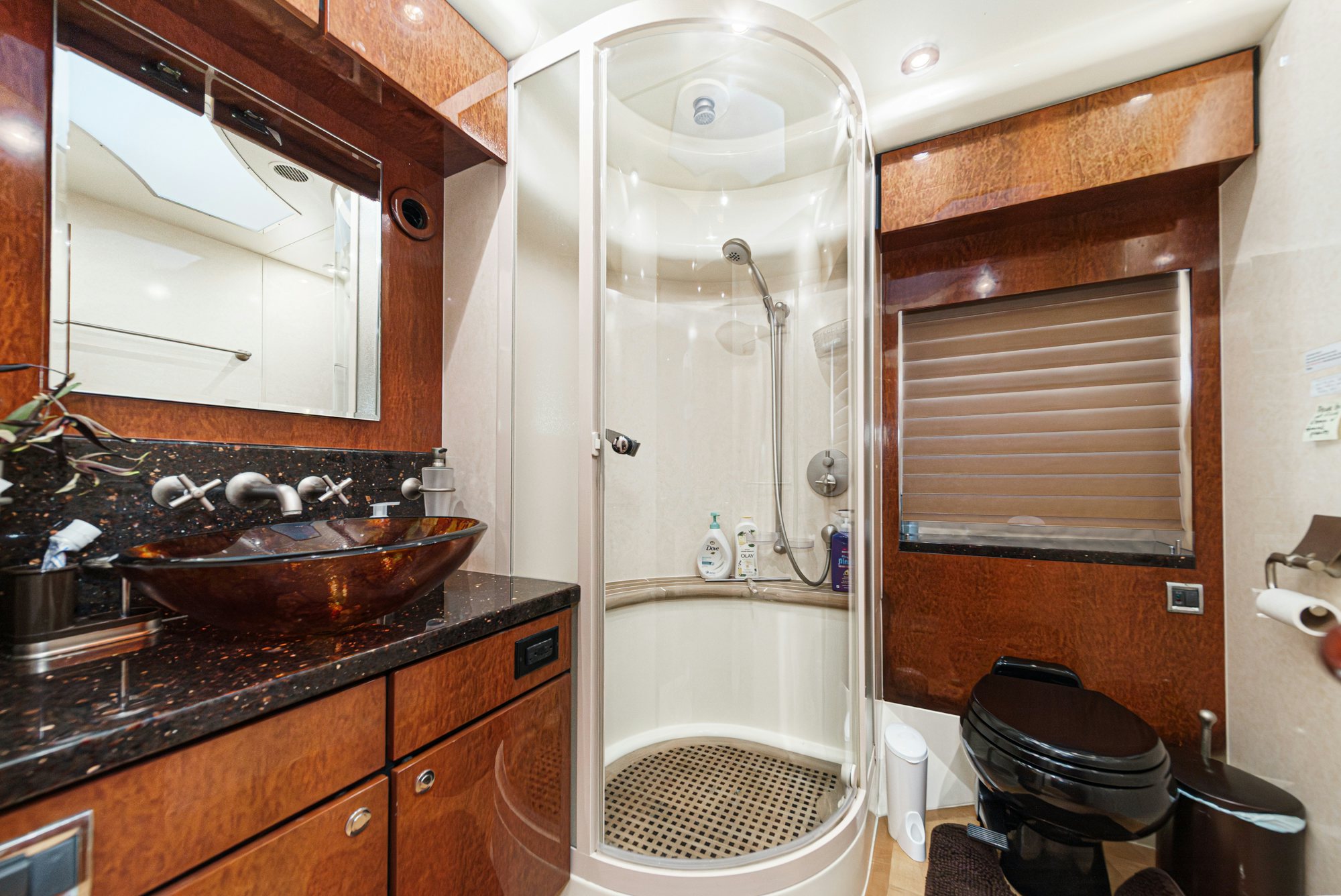 a bathroom with a sink and a bathtub aboard COMPASS ROSE Yacht for Sale
