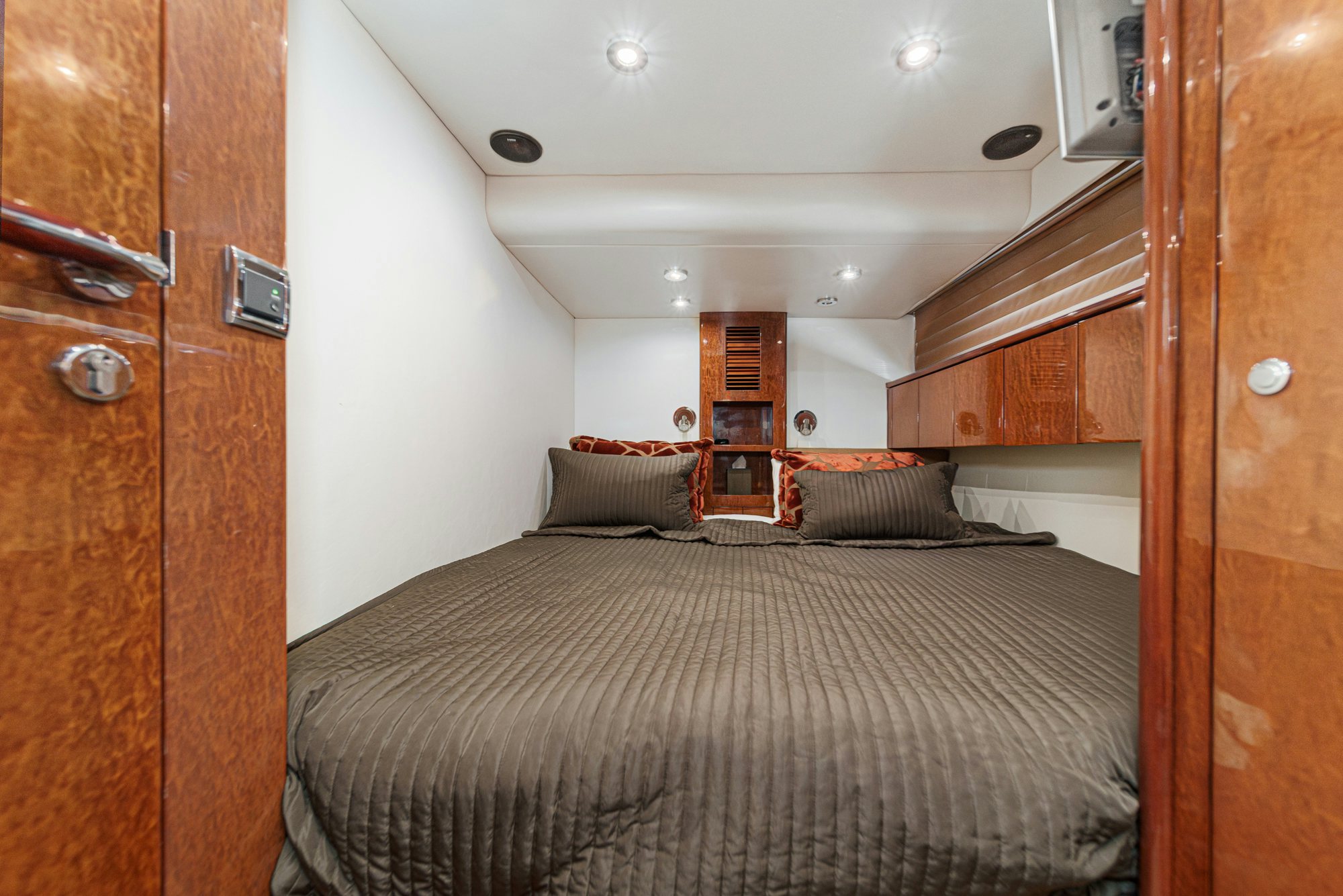 a bedroom with a bed and a closet aboard COMPASS ROSE Yacht for Sale