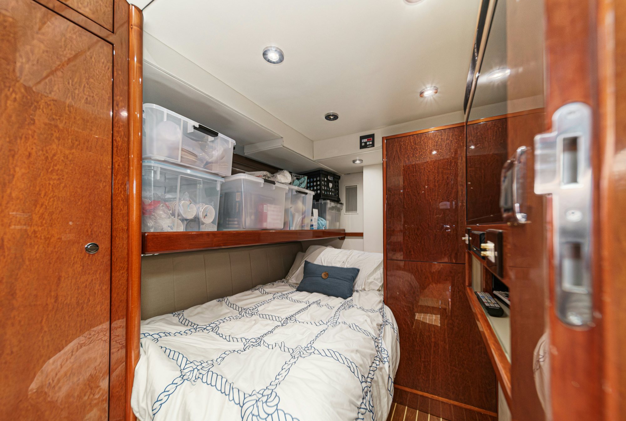 a room with a bed and a closet aboard COMPASS ROSE Yacht for Sale