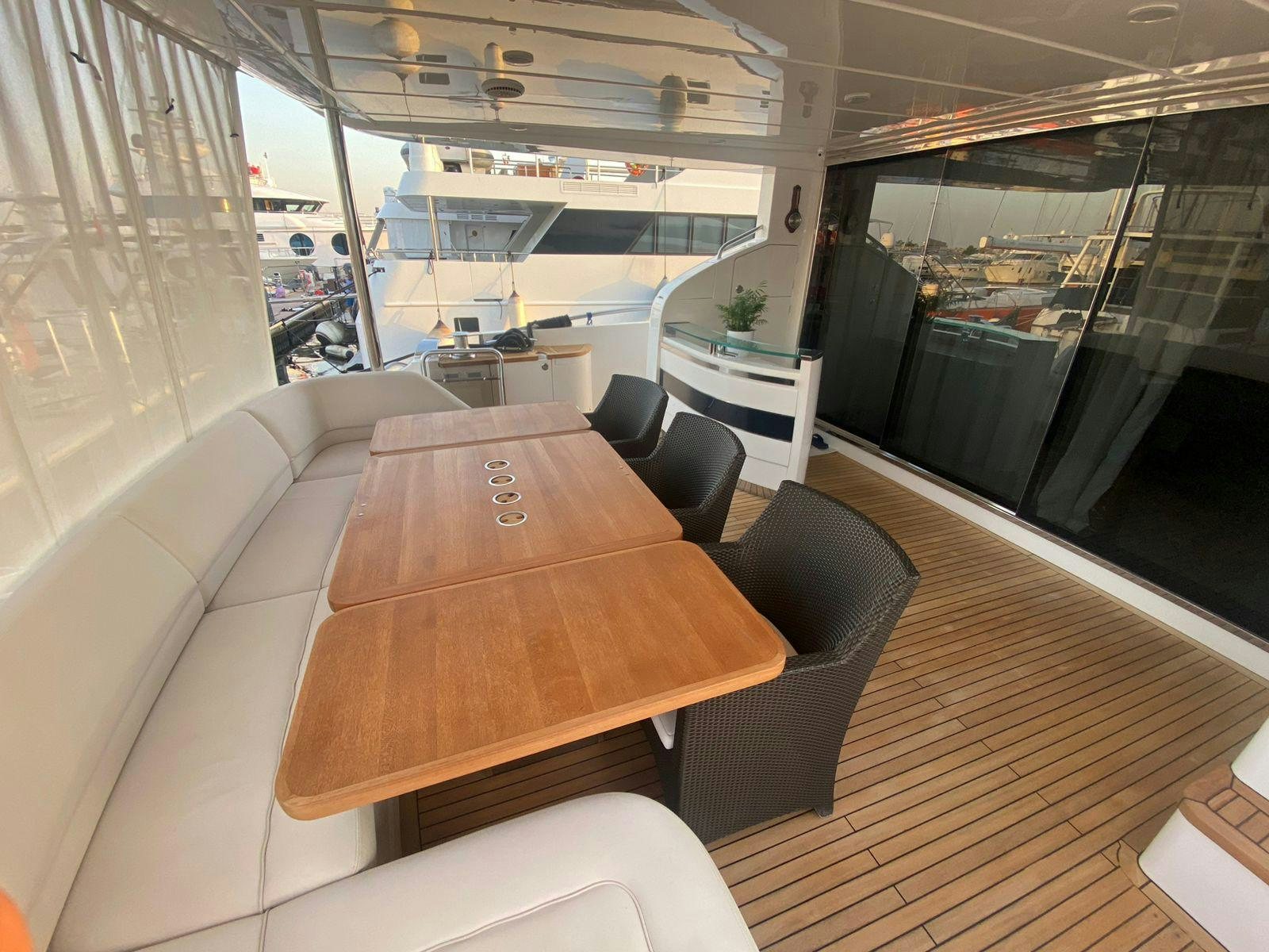 a room with a table chairs and a large window aboard VIXEN Yacht for Sale