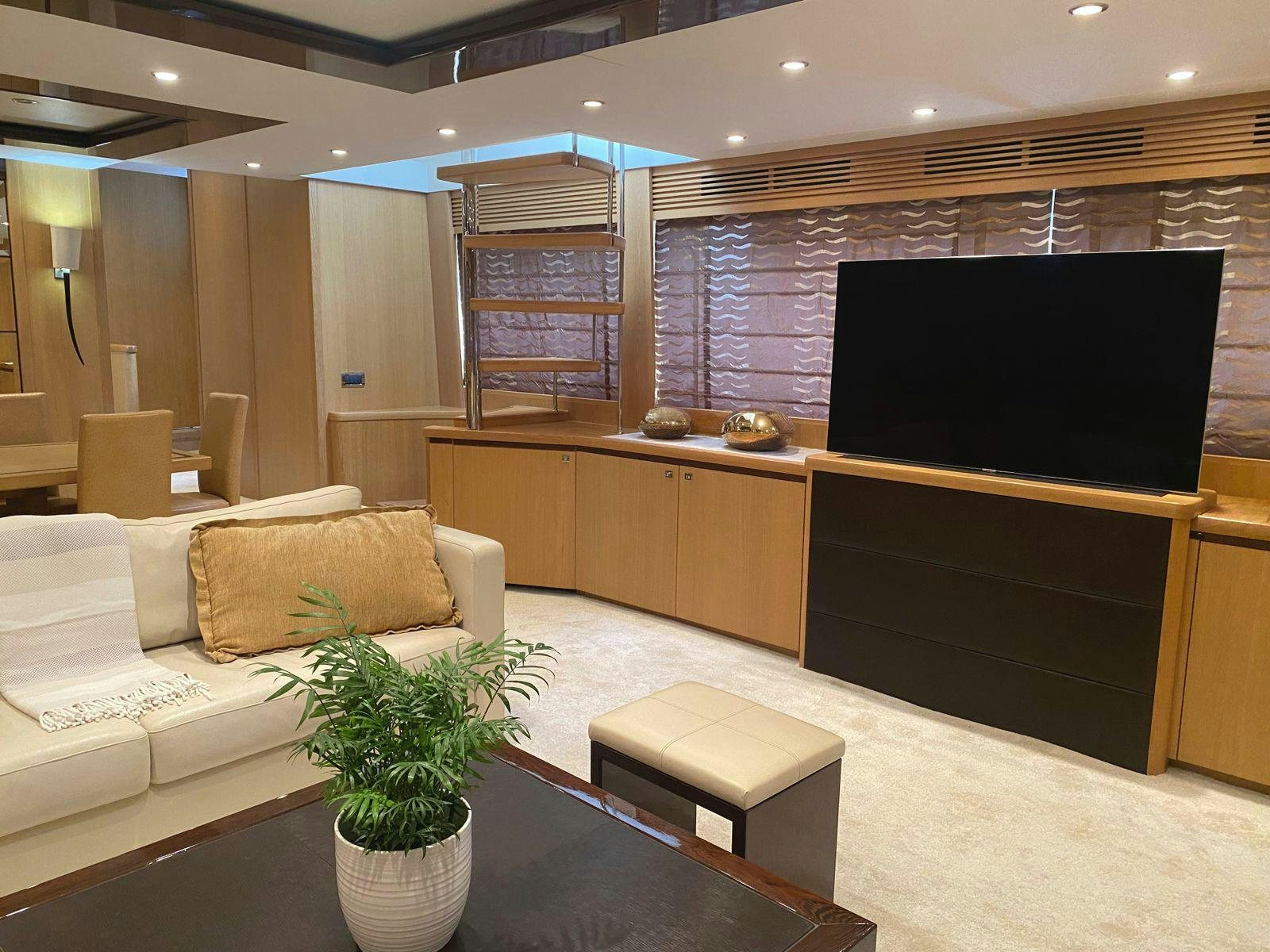 a room with a tv and couches aboard VIXEN Yacht for Sale