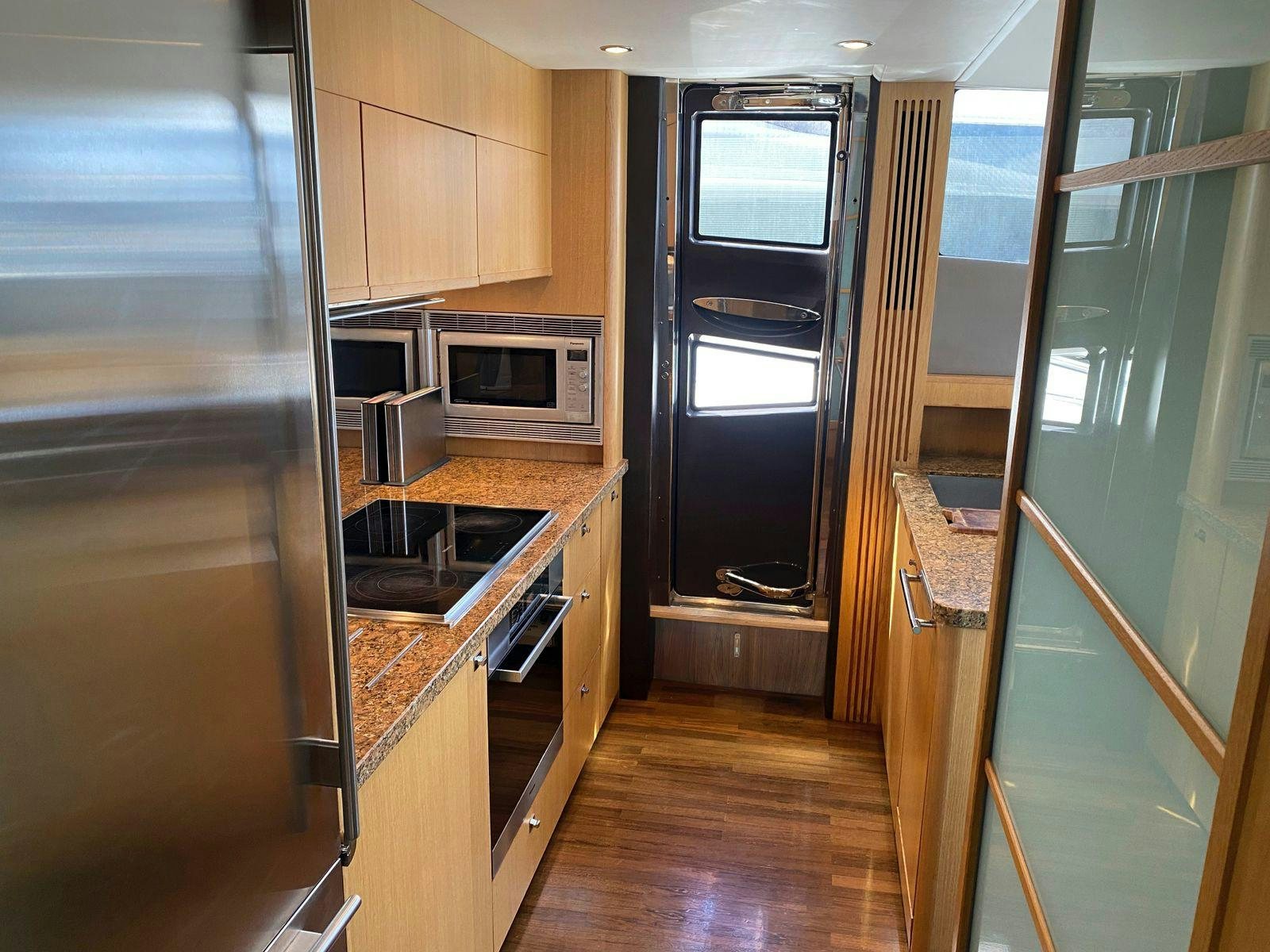 a kitchen with a microwave oven and a refrigerator aboard VIXEN Yacht for Sale