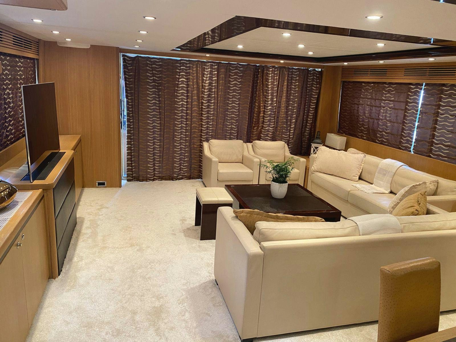 a living room with a couch and a tv aboard VIXEN Yacht for Sale