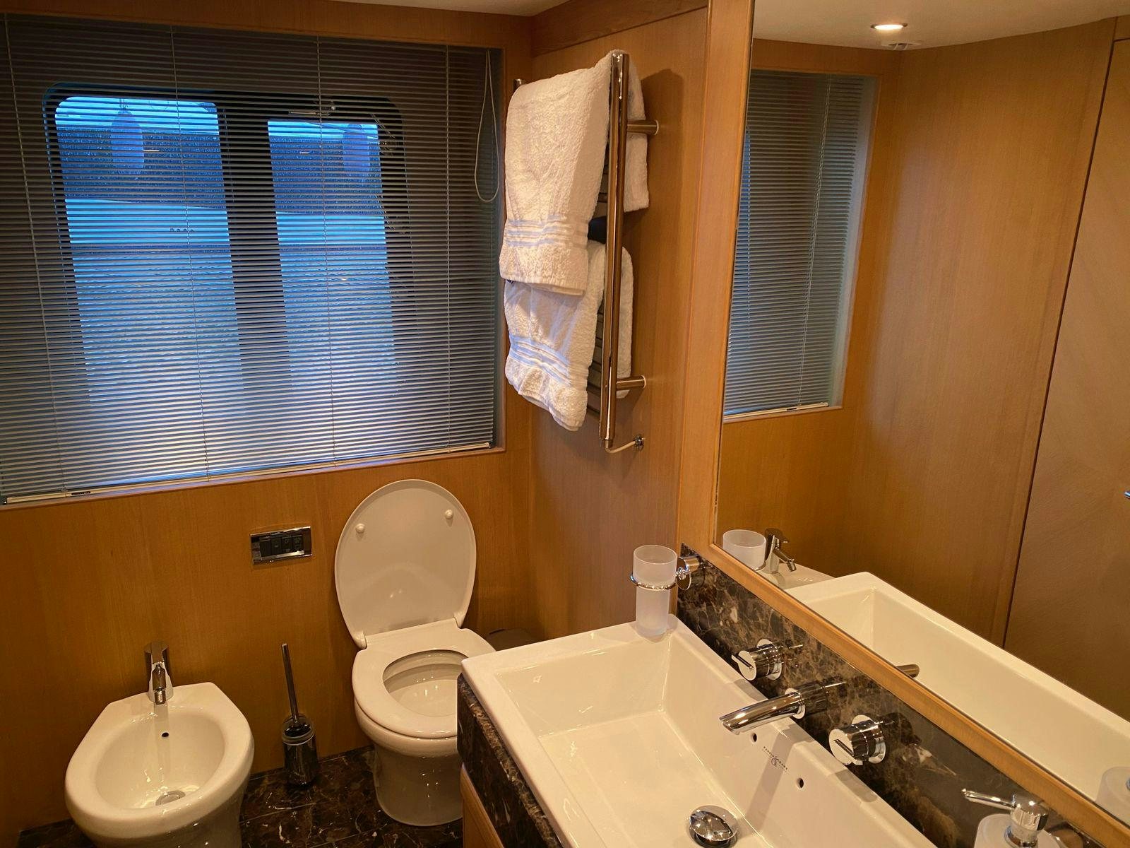 a bathroom with a toilet sink and a bathtub aboard VIXEN Yacht for Sale