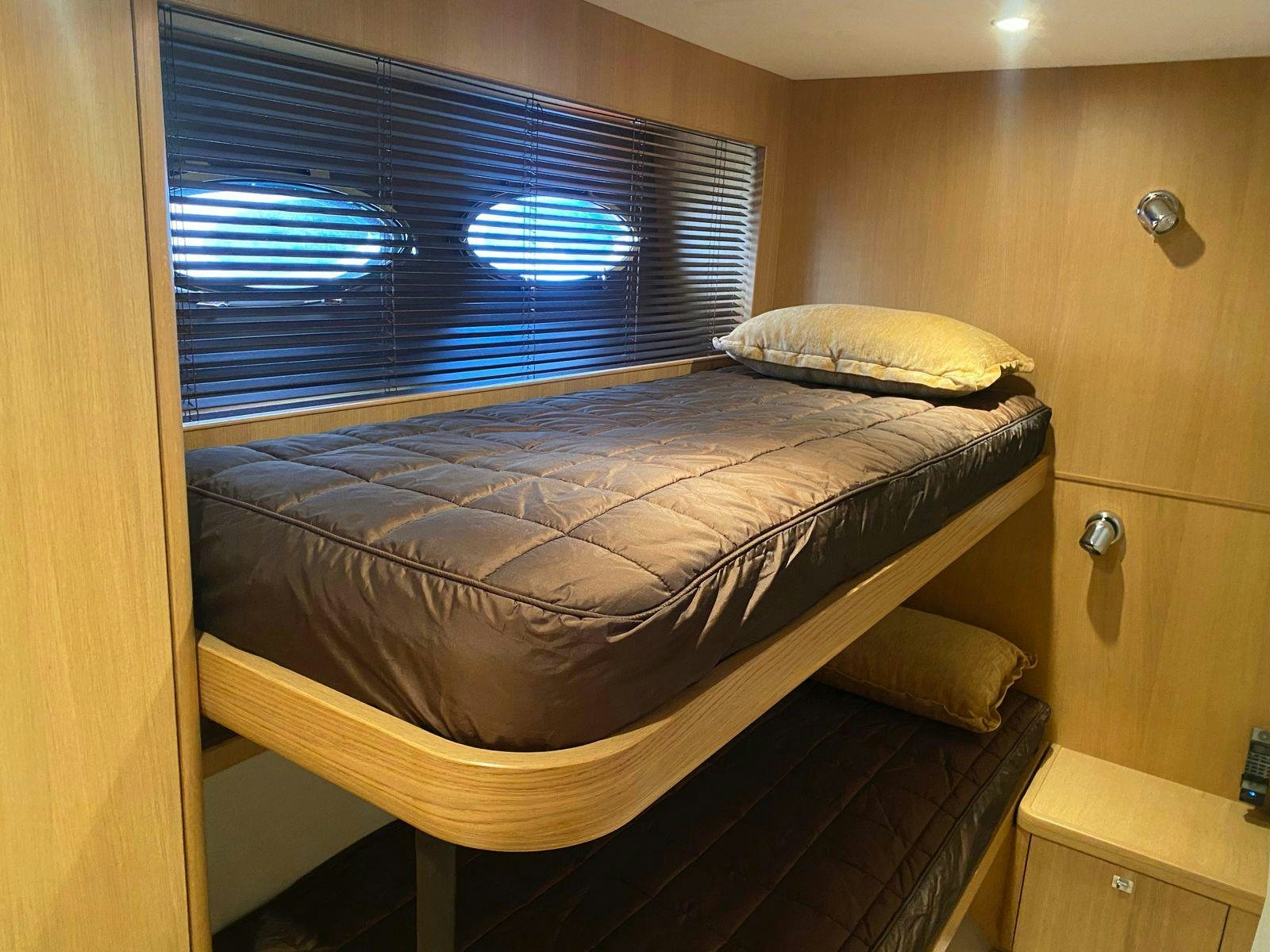 a bed with a blue comforter aboard VIXEN Yacht for Sale