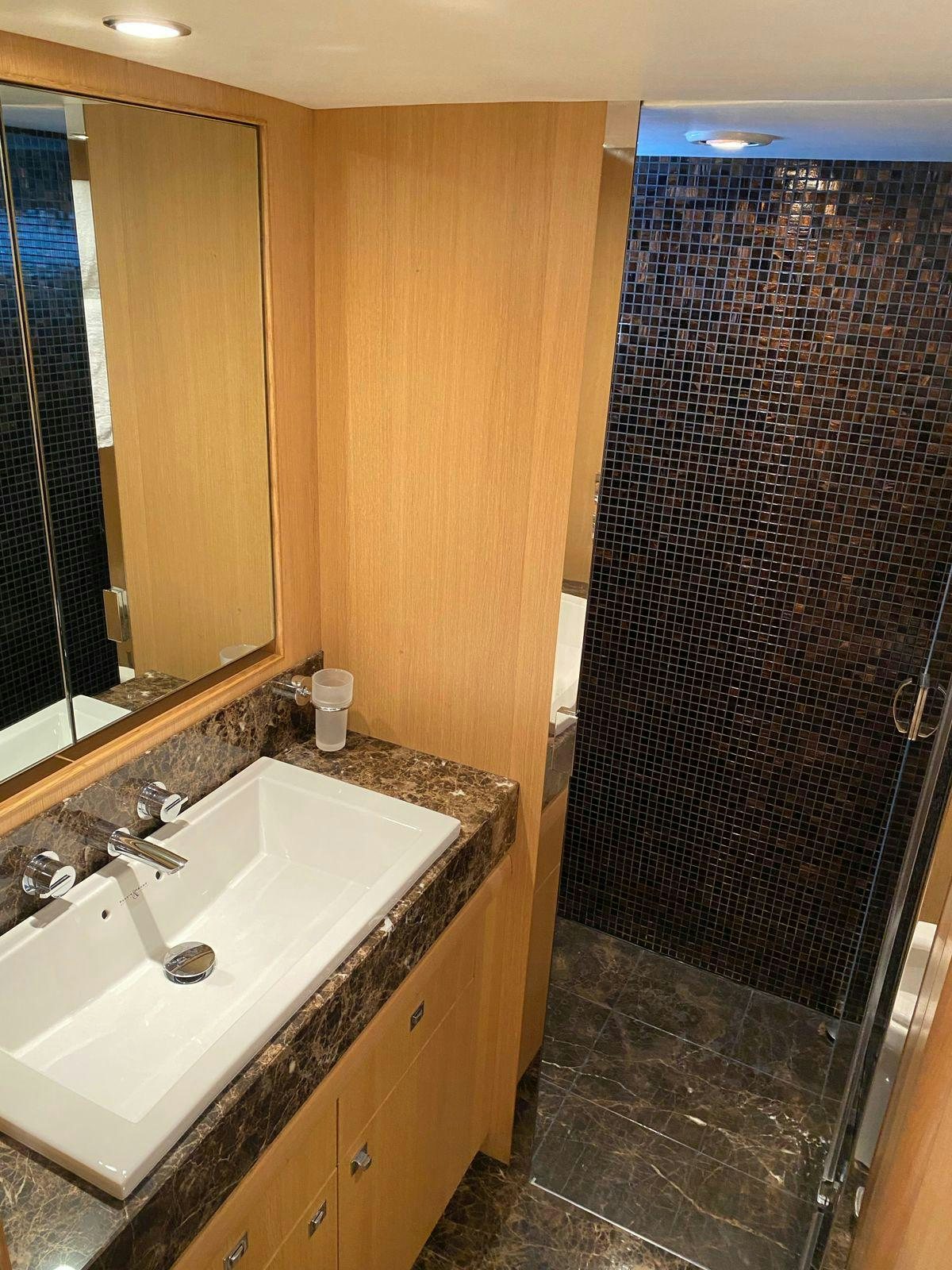 a bathroom with a sink and a shower aboard VIXEN Yacht for Sale
