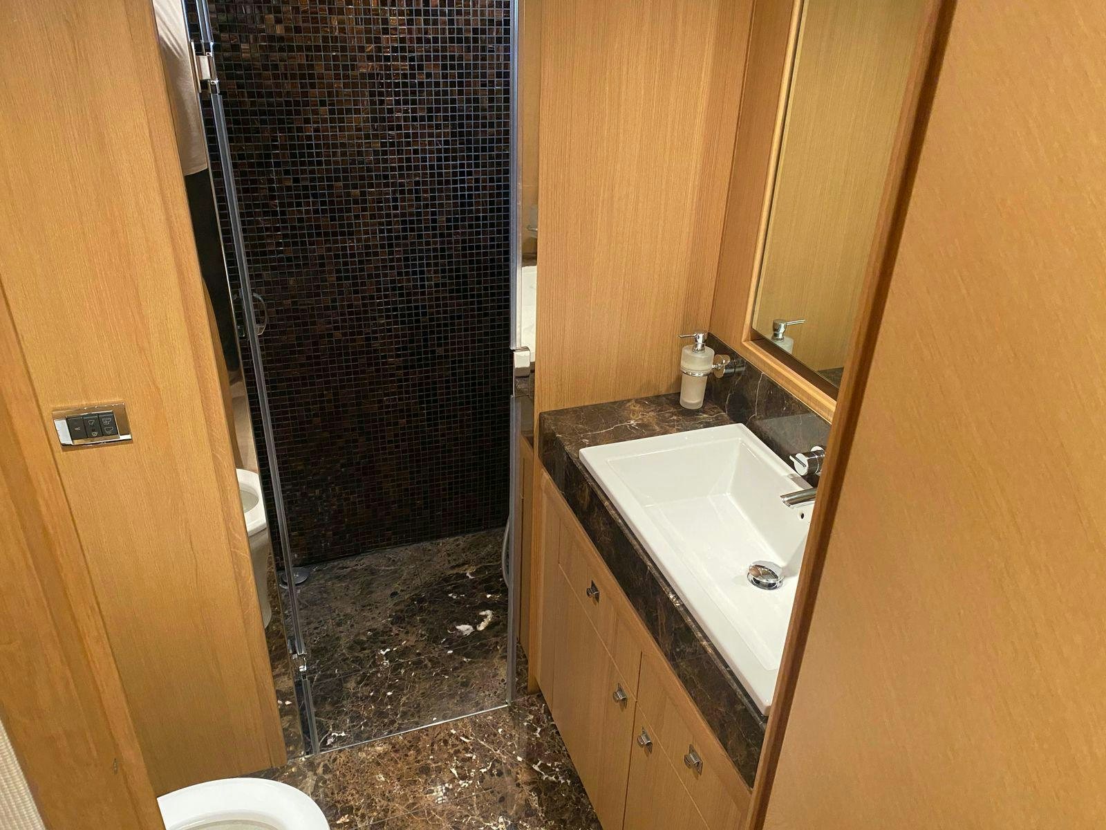 a bathroom with a sink and a shower aboard VIXEN Yacht for Sale
