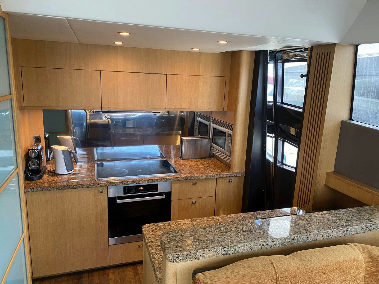 a kitchen with wooden cabinets aboard VIXEN Yacht for Sale