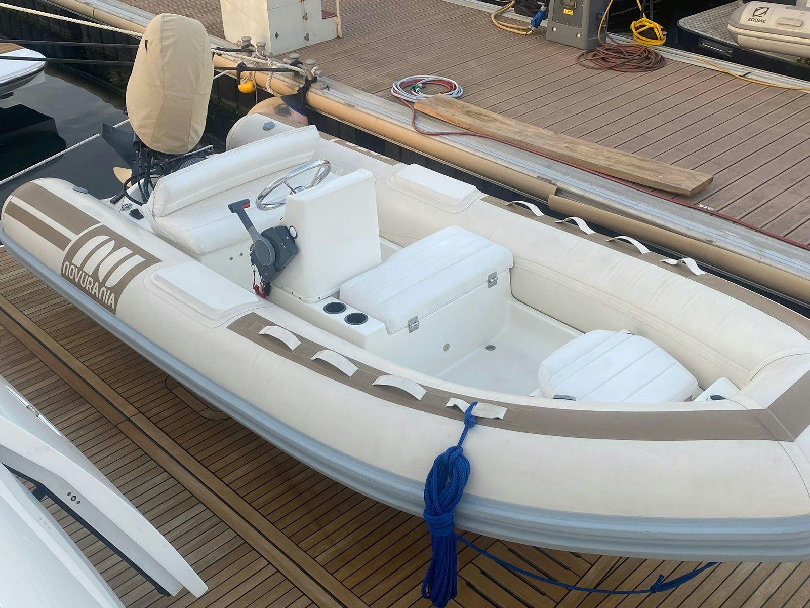 a white boat with a blue bow aboard VIXEN Yacht for Sale
