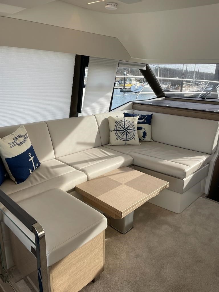 a living room with a couch and a window aboard SEAS THE DAY Yacht for Sale