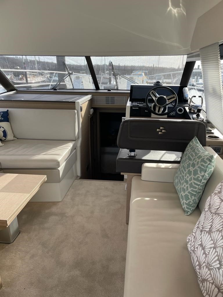 a room with a couch and a table and a fan aboard SEAS THE DAY Yacht for Sale