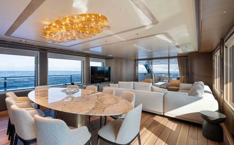 a large living room with a large chandelier aboard SERENISSIMA I Yacht for Charter