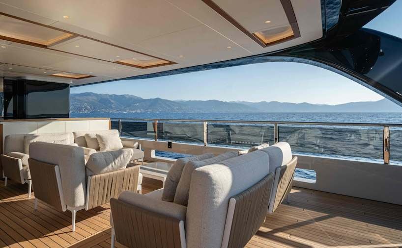 a large living room with a large balcony overlooking the ocean aboard SERENISSIMA I Yacht for Charter