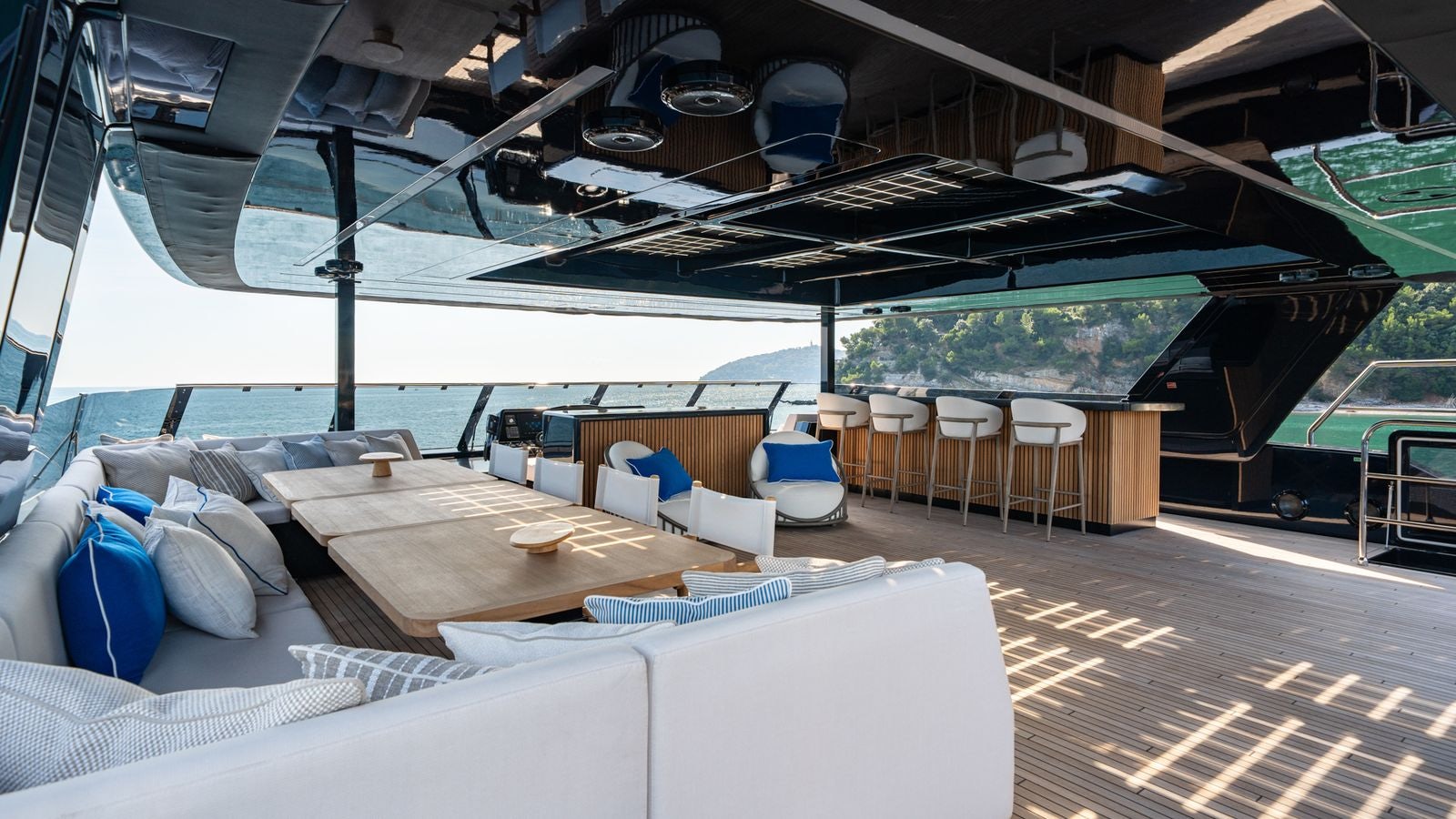 a large lounge area with a large lounge chair and a large bed aboard PETITE BELLE Yacht for Sale