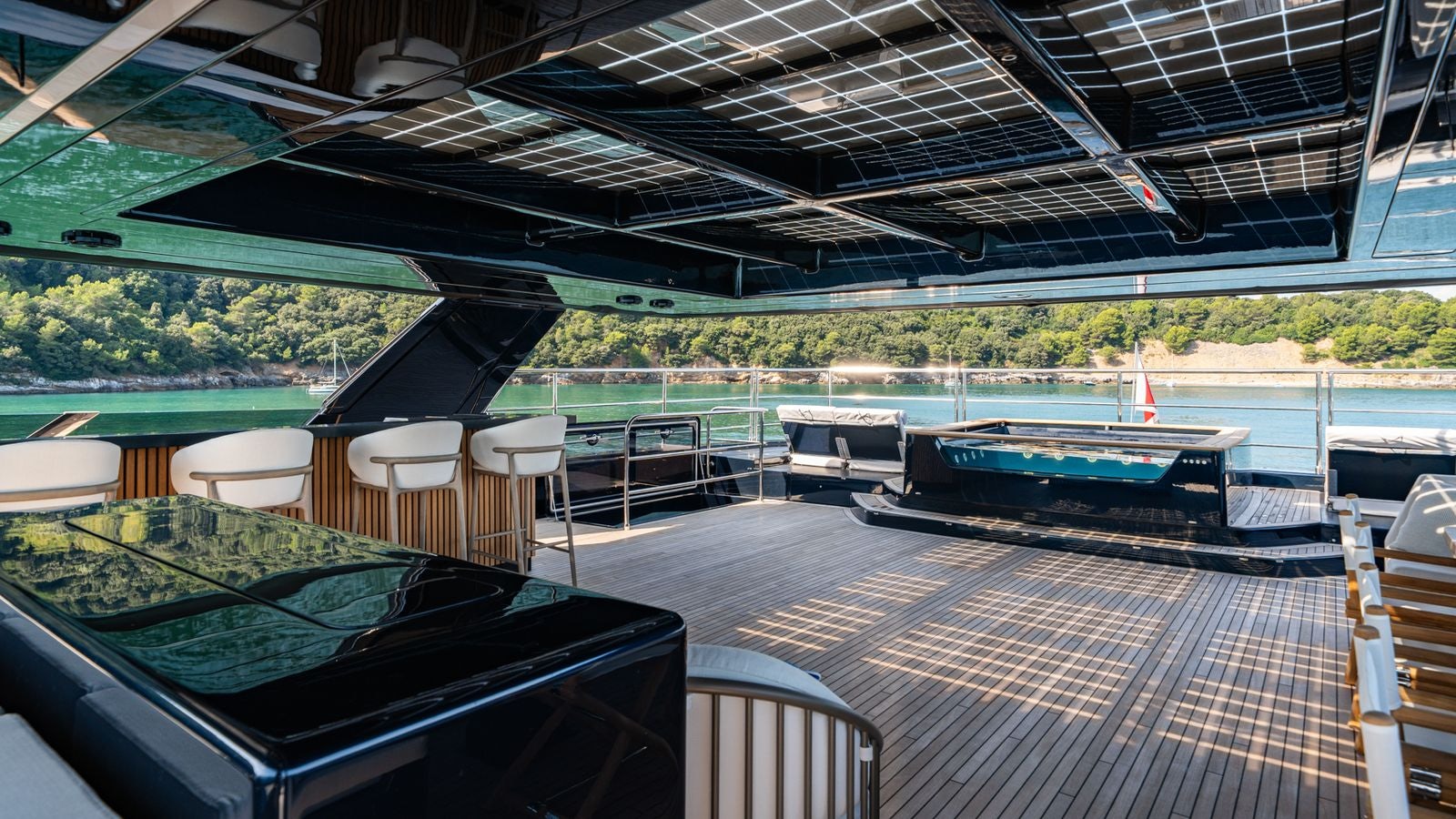 a deck with a pool and a deck with chairs and tables aboard PETITE BELLE Yacht for Sale