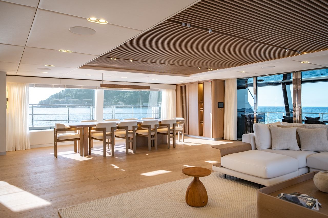 a living room with a large window aboard PETITE BELLE Yacht for Sale
