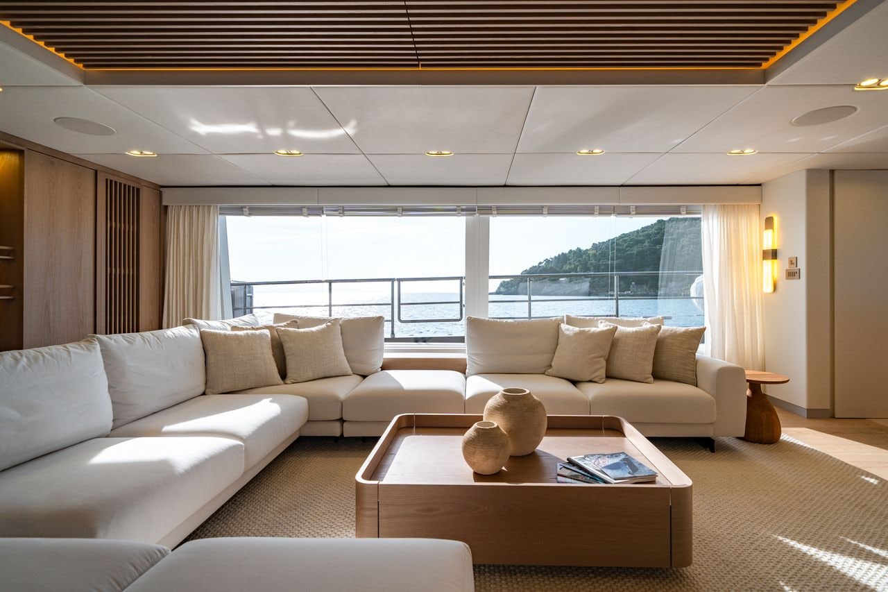 a living room with a large window aboard PETITE BELLE Yacht for Sale