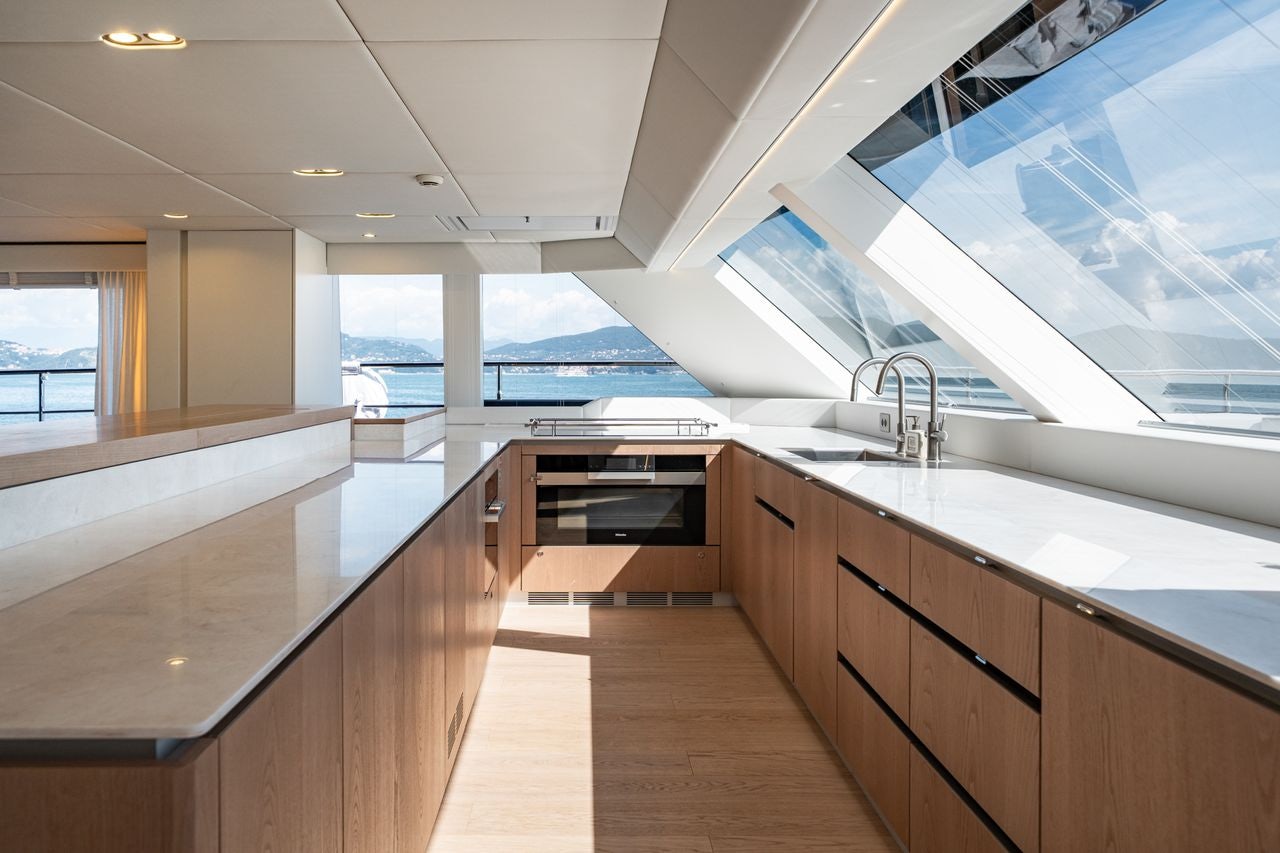 a kitchen with a large window aboard PETITE BELLE Yacht for Sale