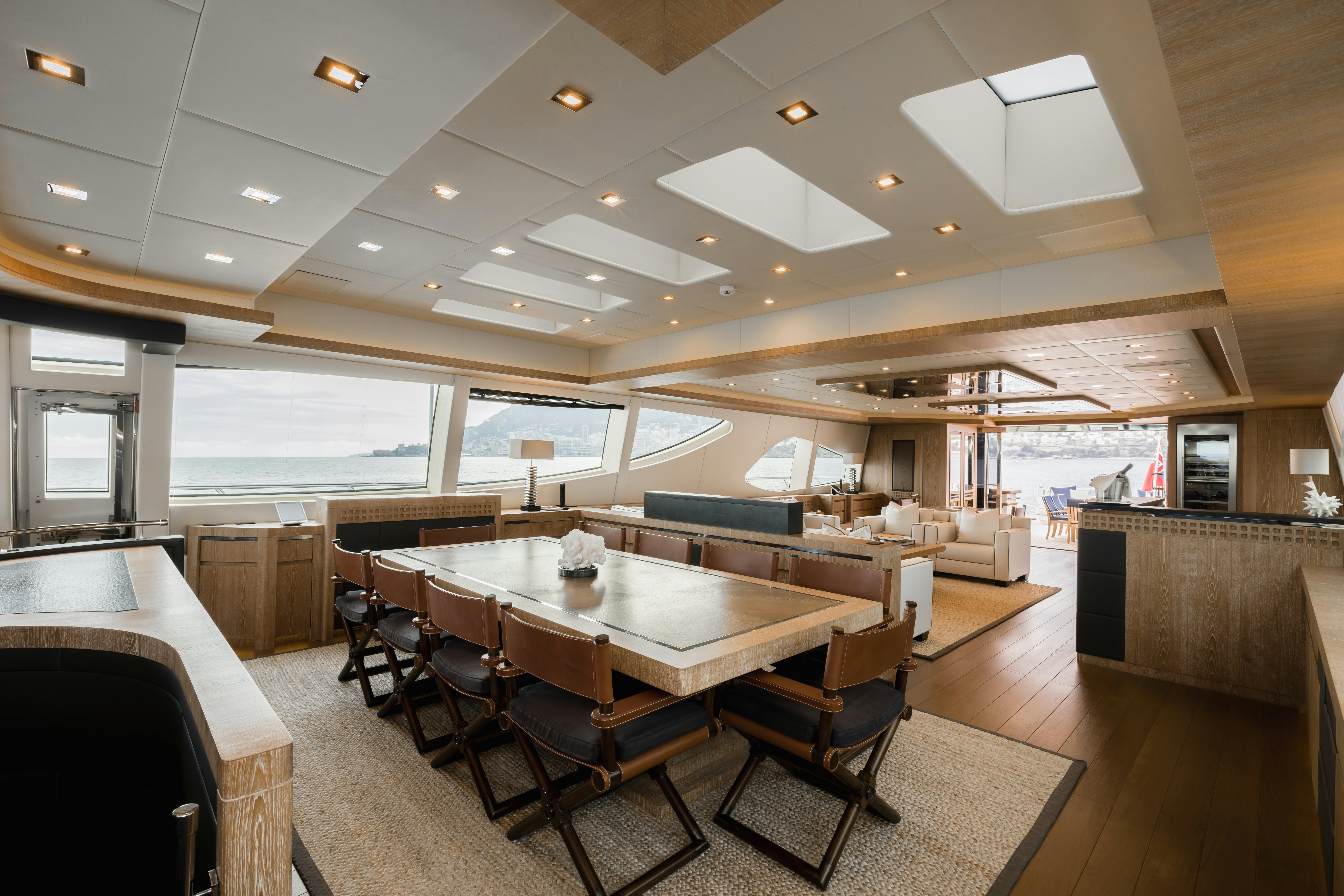 a large living room with a large table and chairs aboard ROYALE X Yacht for Charter