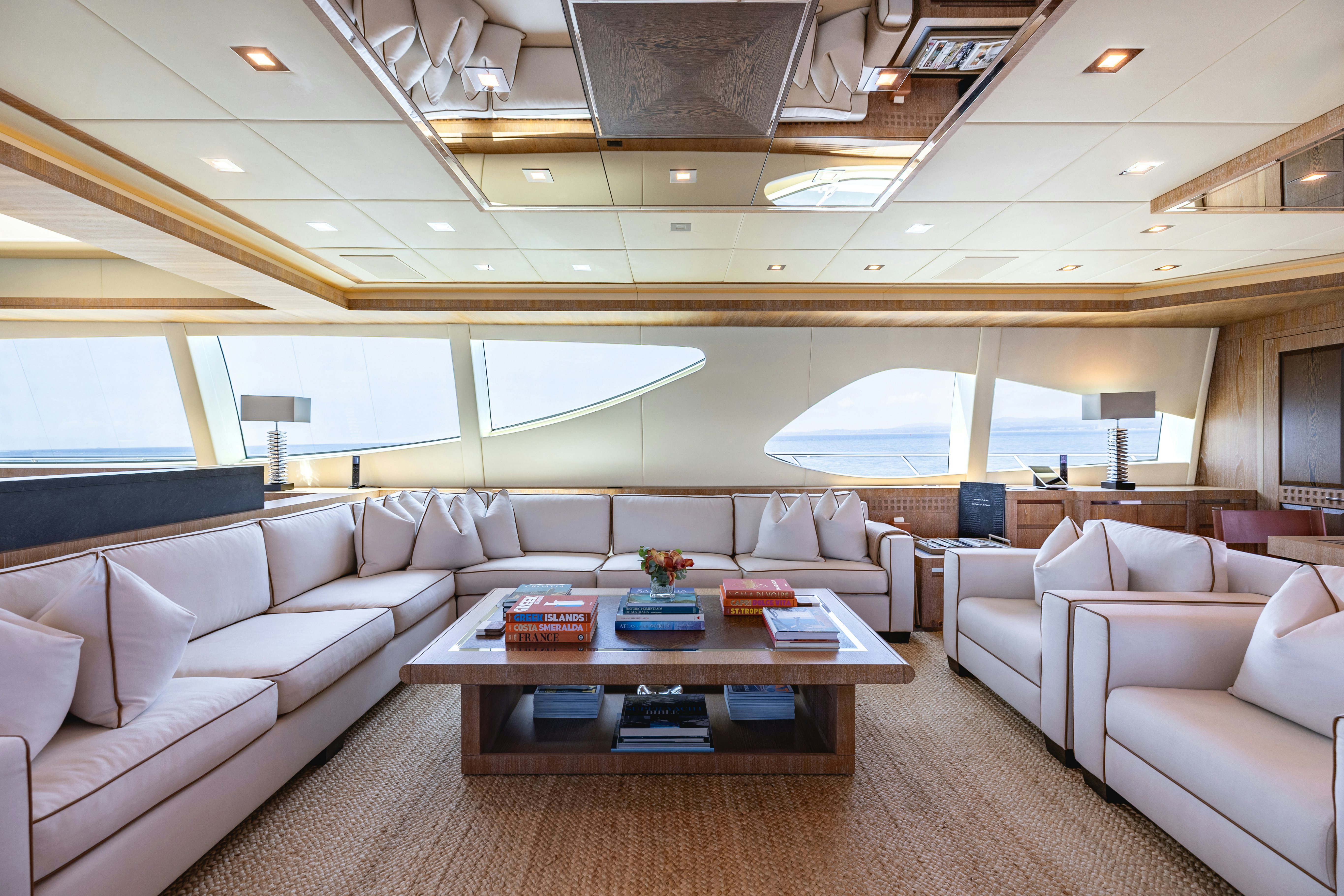 a living room with a large window aboard ROYALE X Yacht for Charter